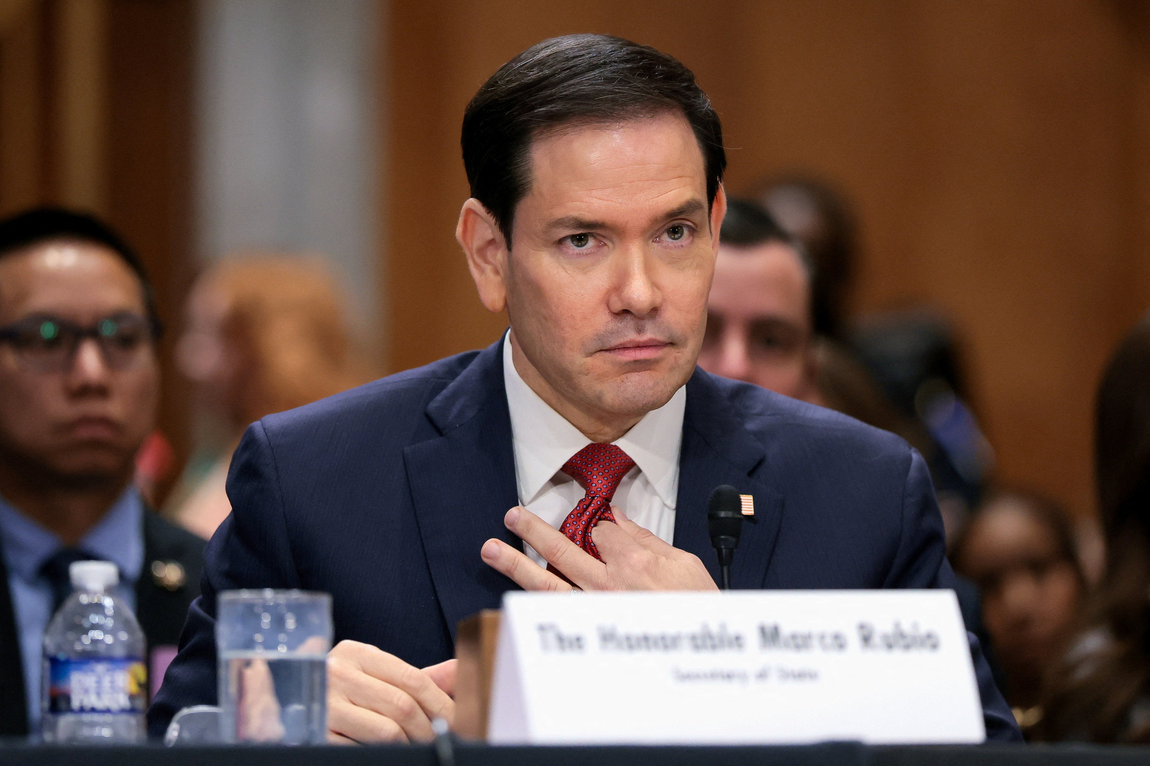 U.S. Secretary of State Marco Rubio adjusts his tie as he attends a U.S. Senate Foreign Relations Committee