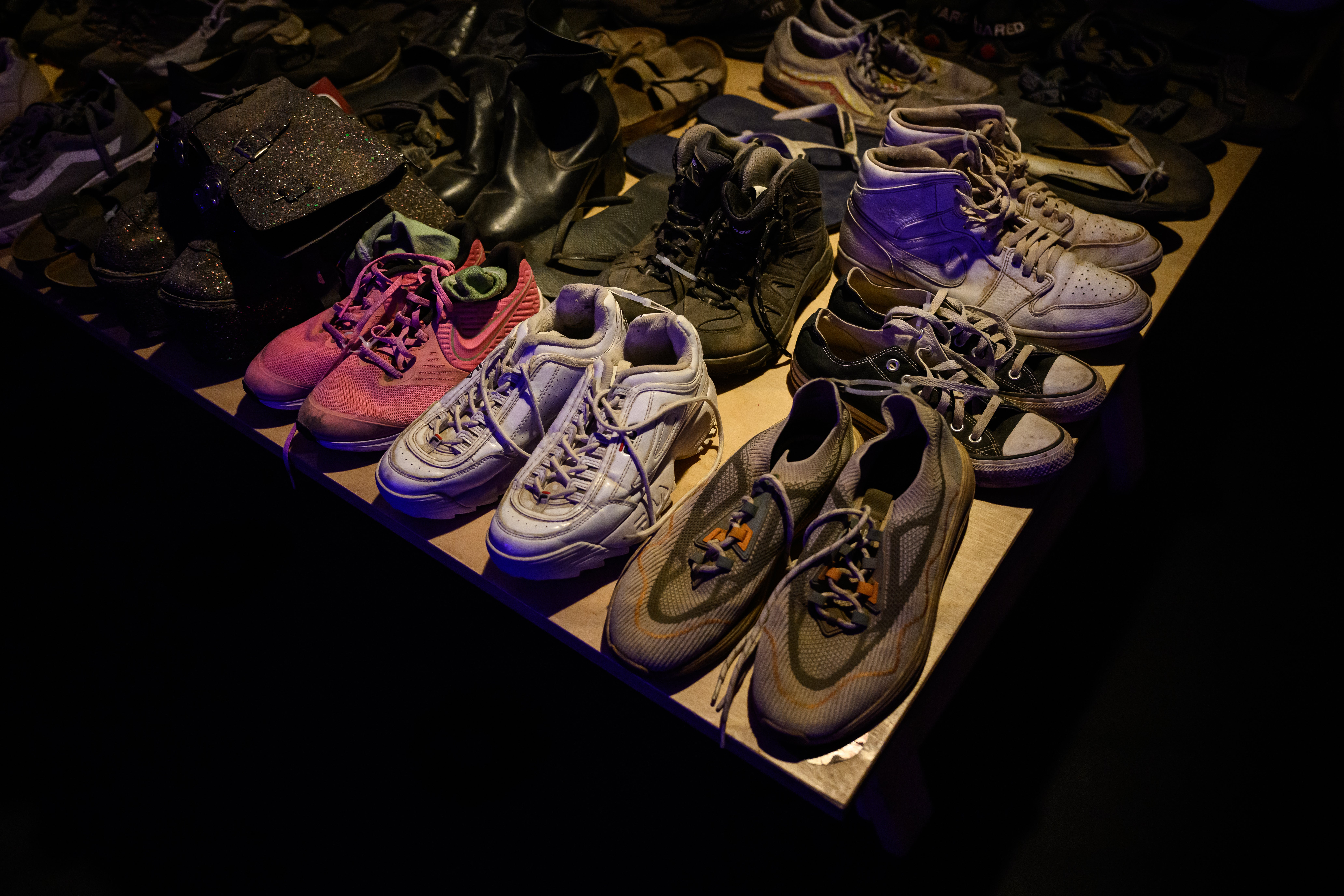 Rows of shoes recovered from the festival site are displayed at the Nova Exhibition, 