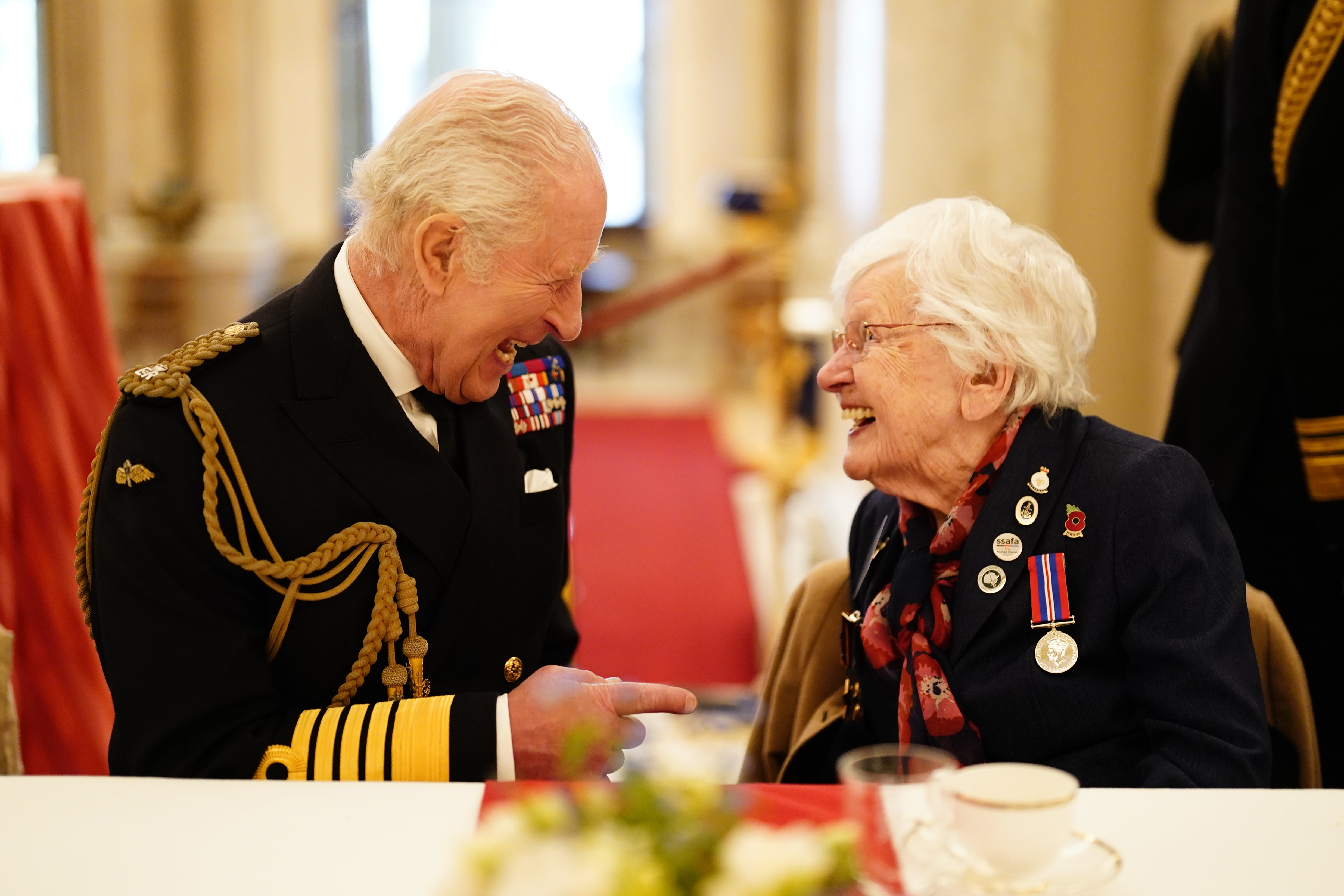 The King joins Second World War veteran Ruth Barnwell at a tea party in Buckingham Palace following the military procession to mark the 80th anniversary of VE Day (Jordan Pettitt/PA)