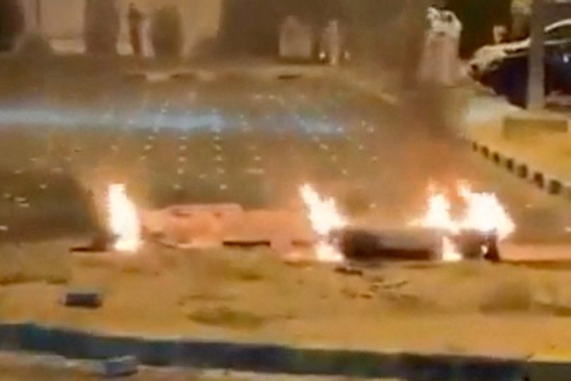 Debris burns on the ground in a parking lot following reports of missile and drone attacks, in Sabah Al Nasser, Kuwait June 3, 2026, in this screengrab obtained from a social media video . (Reuters)