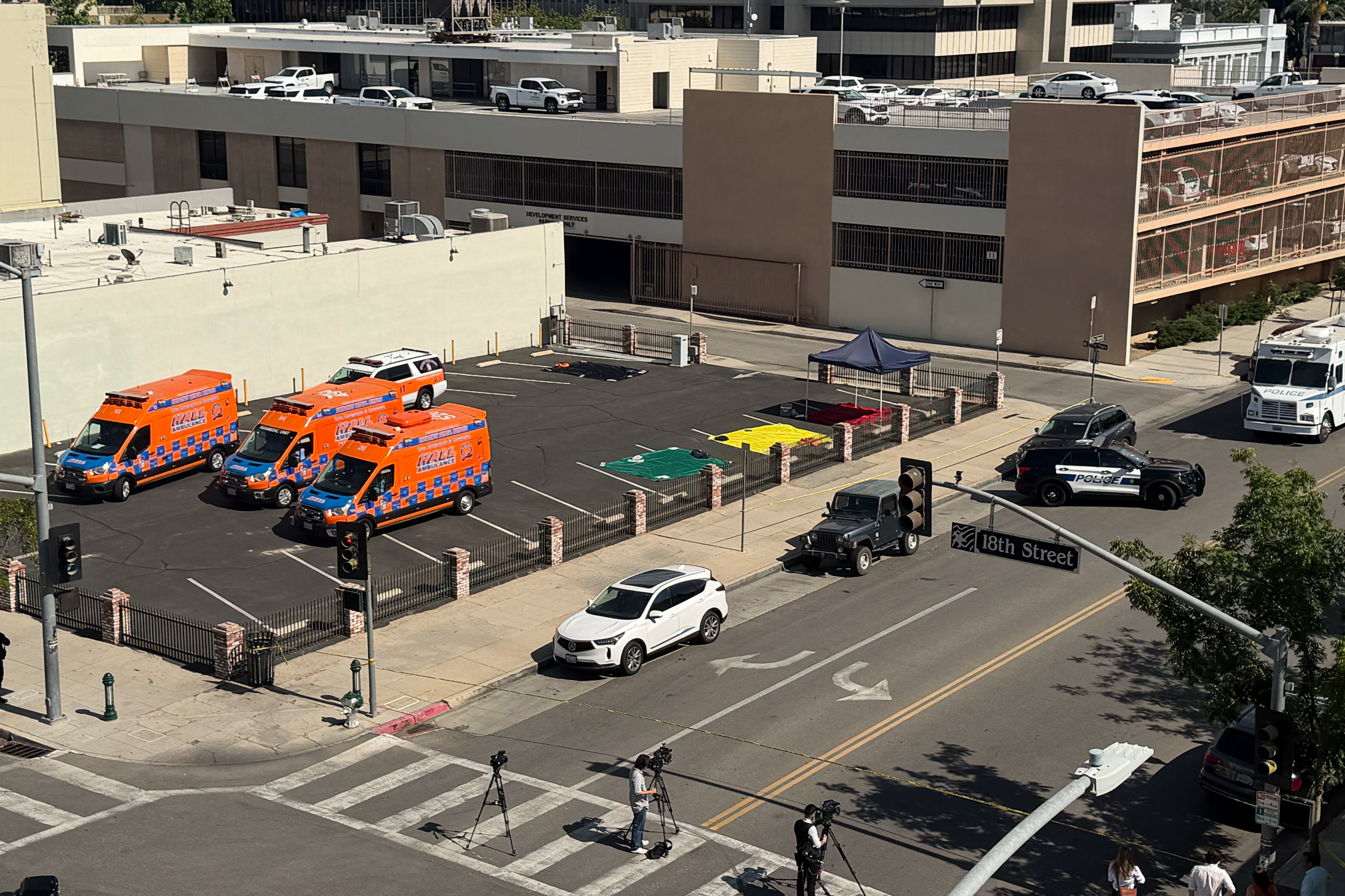 An overhead view shows police and media responding after a man barricaded himself inside a bank (AP)