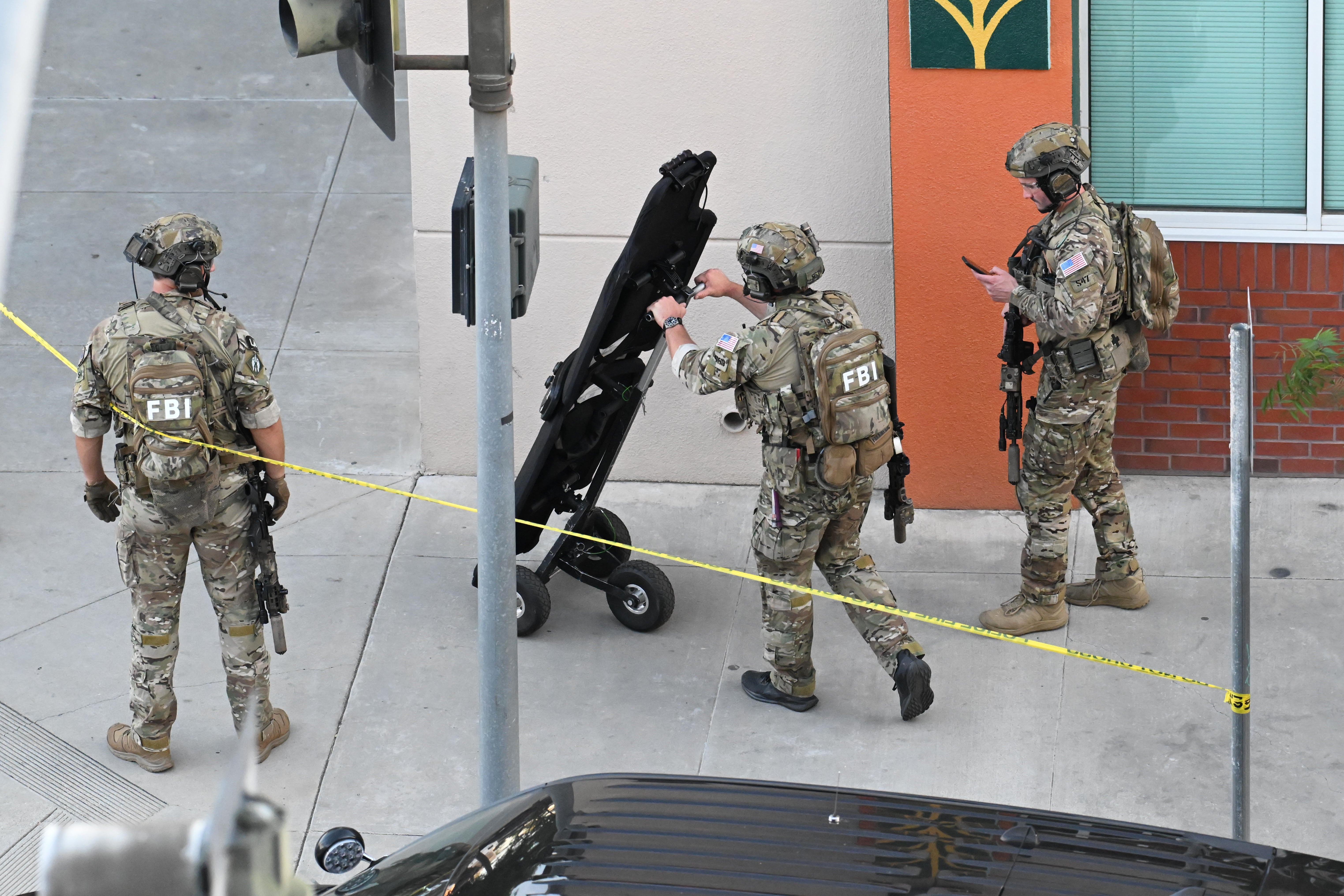FBI agents respond after a man barricaded himself inside a building with hostages (AP)