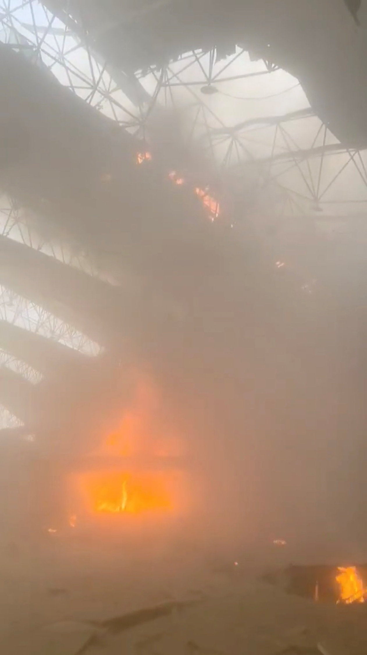 Flames and smoke rise from a fire in the aftermath of Iranian strikes at Kuwait International Airport in Kuwait City (Reuters)