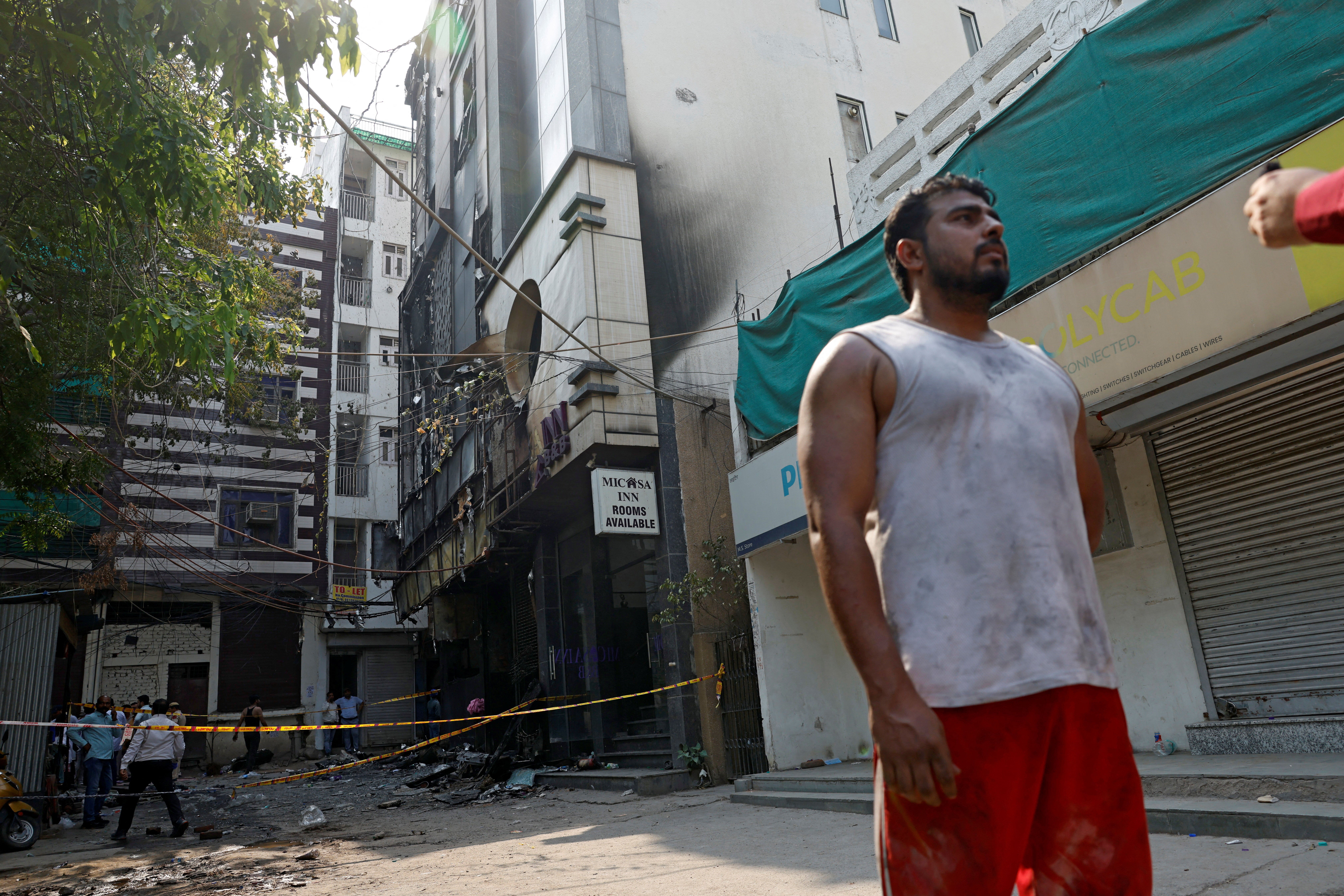 Mohammad Shoaib, 30, a resident who said he helped rescue victims, speaks with the media at the site of a hotel fire in New Delhi, India (Reuters)