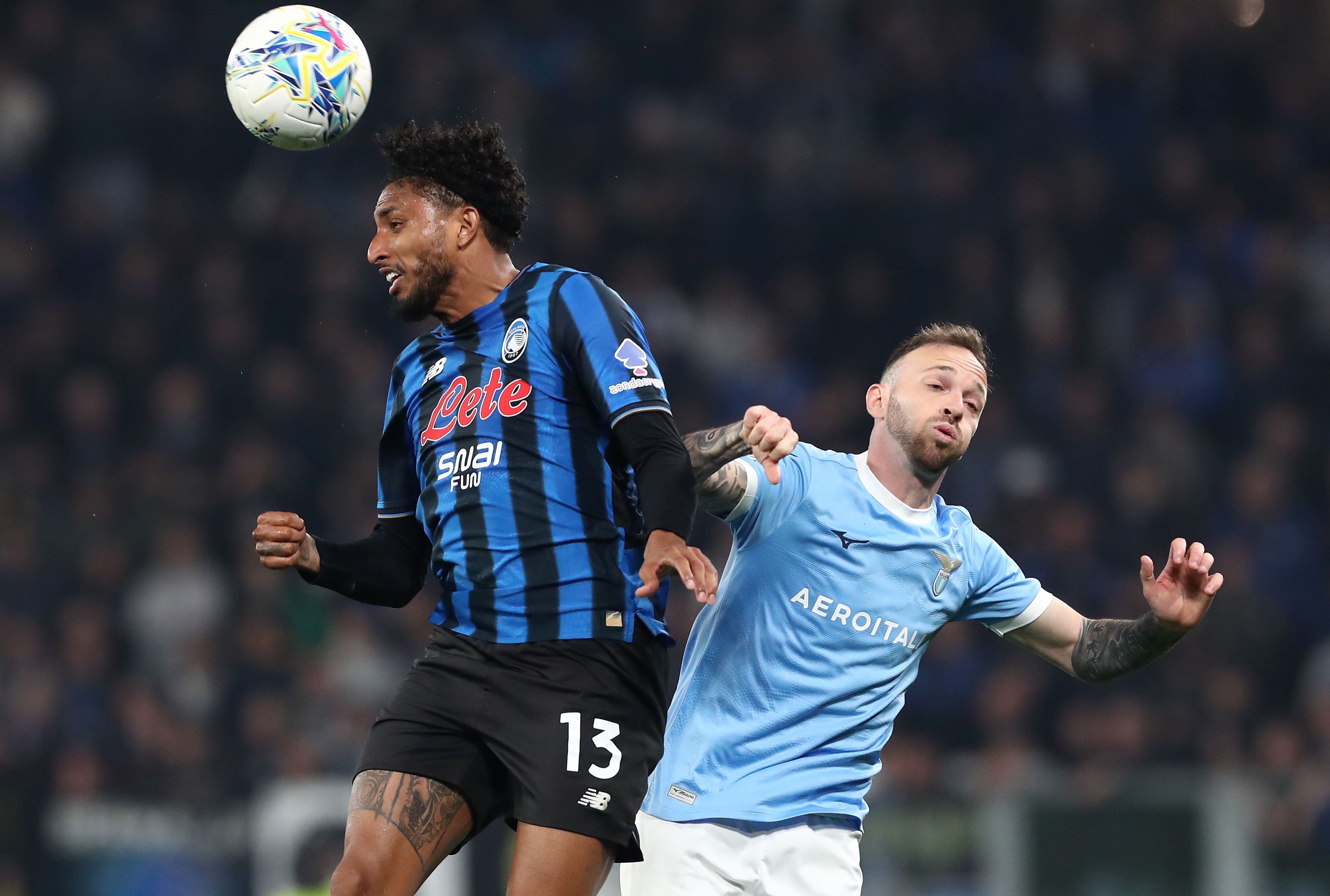 Ederson of Atalanta and Manuel Lazzari of Lazio jump for the ball (Getty)