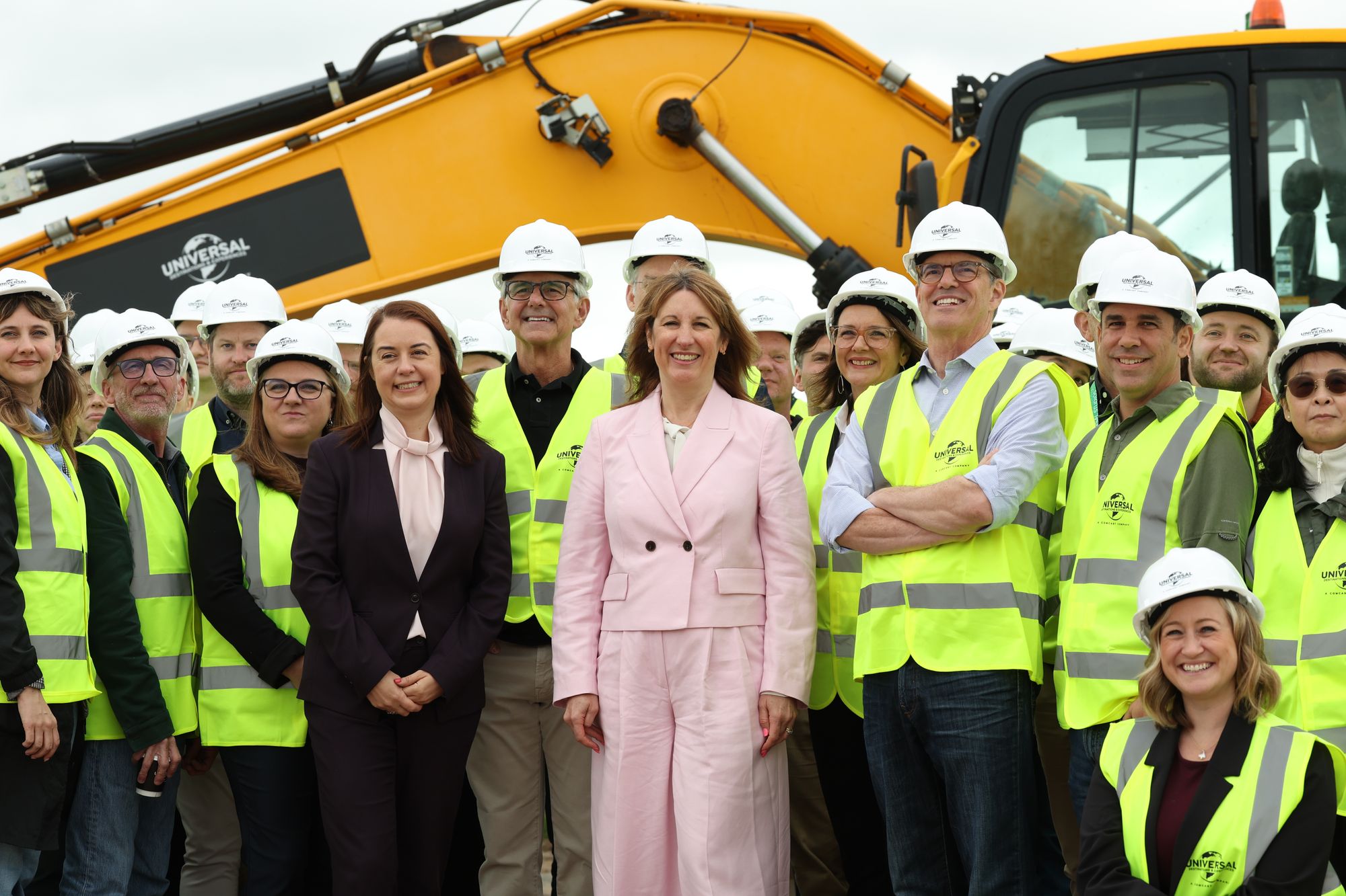 Rachel Reeves poses for a group photo with workers during a visit to the site of the Universal theme park in Bedford