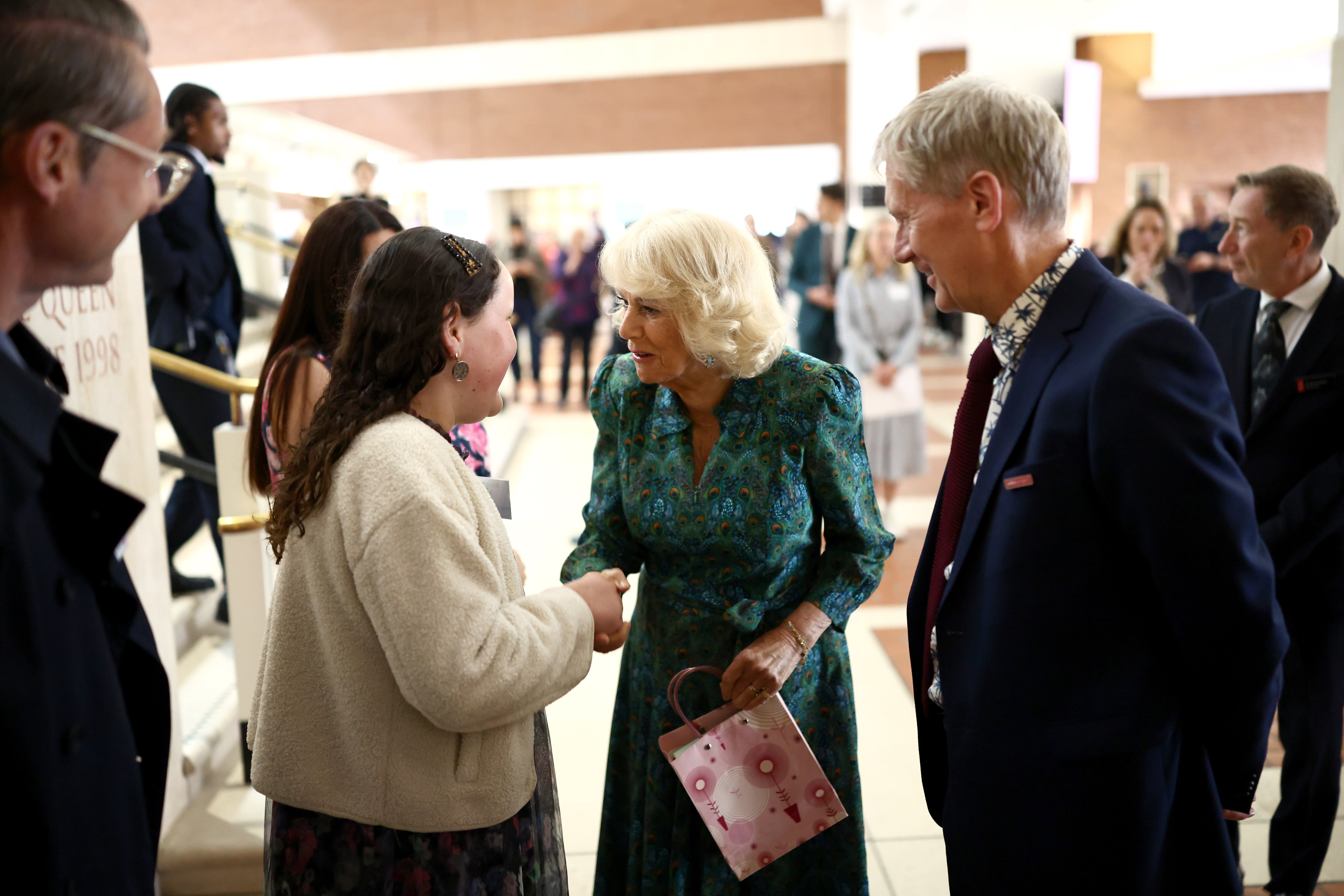 The Queen was greeted by a well-wisher as she arrived at the venue (Henry Nicholls/PA) (PA Wire)