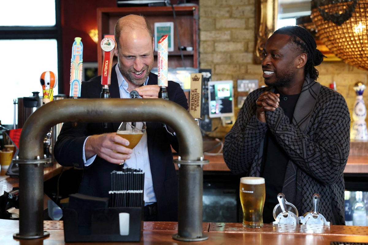 Prince William declares his love for pubs as he pours himself a pint during surprise visit
