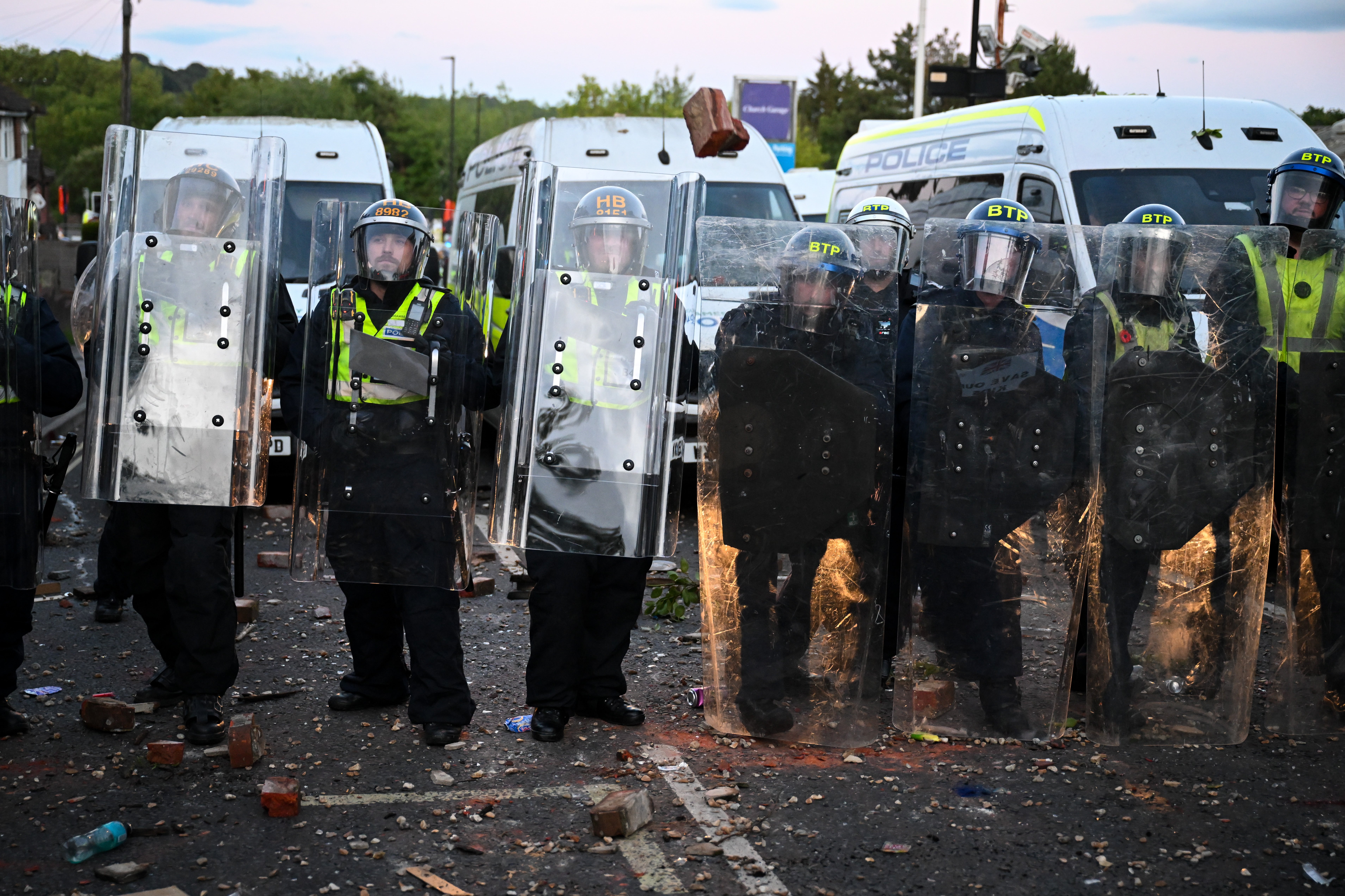 Protesters confront riot police near the location where Henry Nowak died, during a demonstration over the police's handling of the incident
