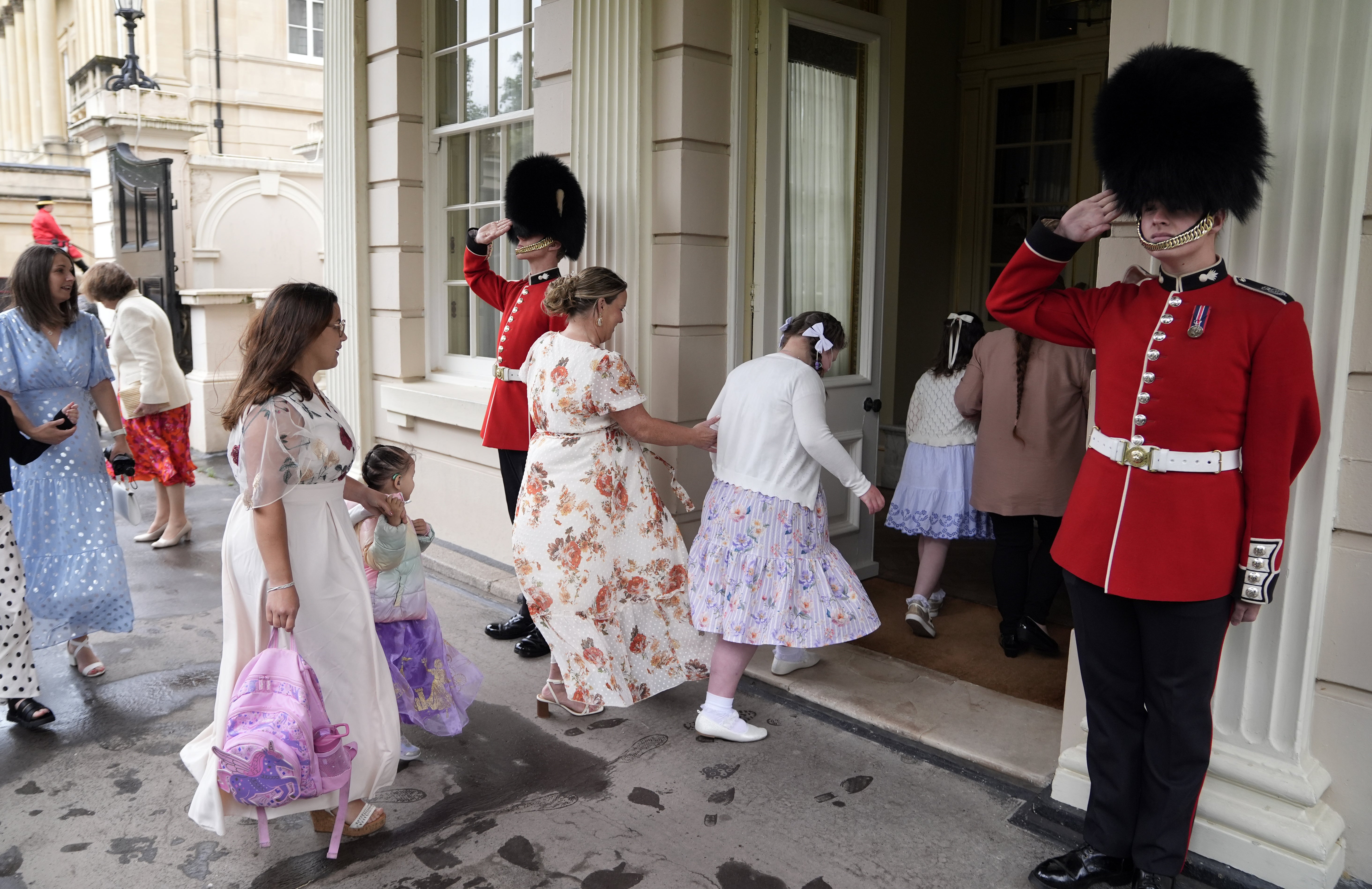 Guardsmen from the Grenadier Guards salute as children and families arrive at Clarence House (Andrew Matthews/PA) (PA Wire)