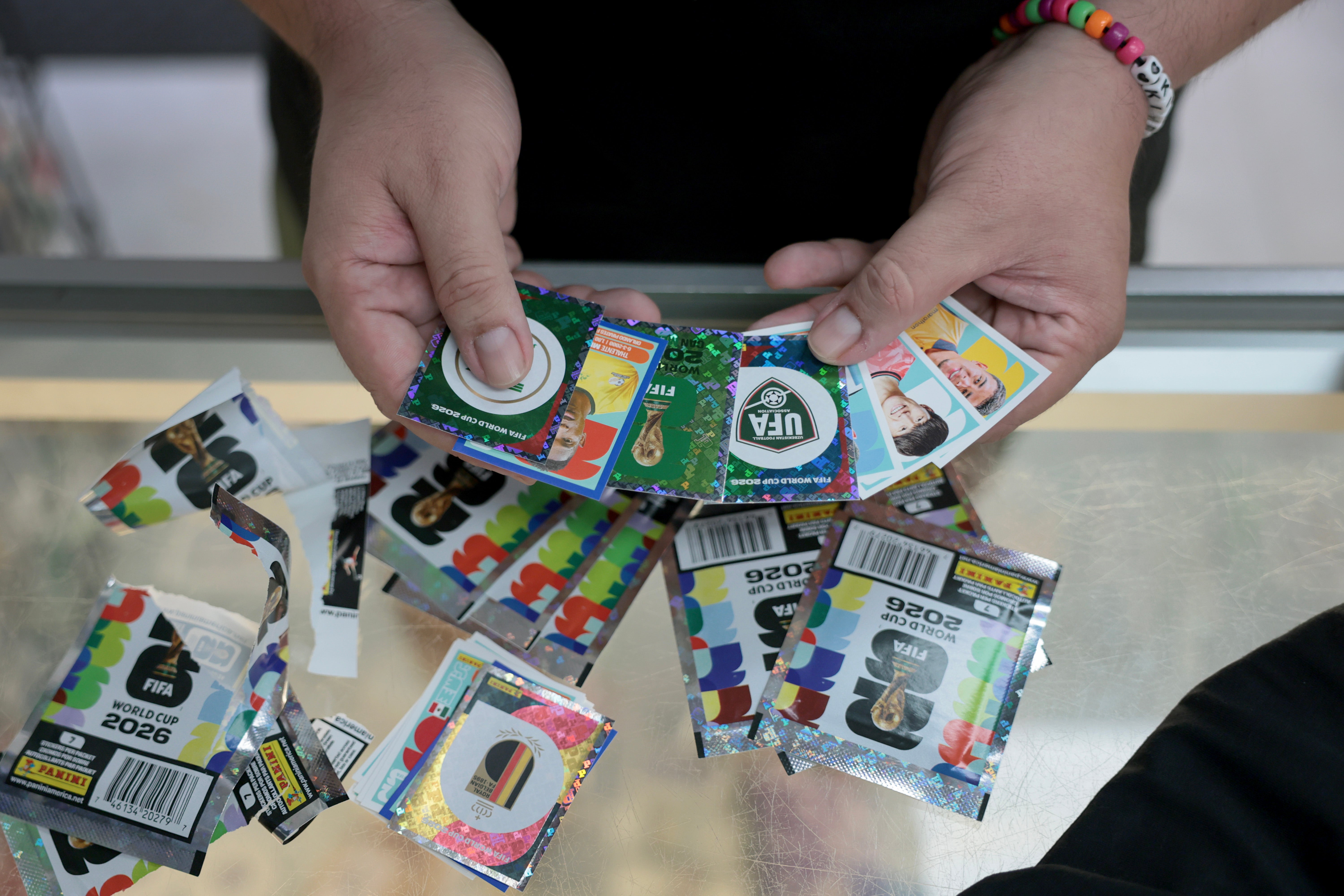 Kimber V. shows off some of the FIFA World Cup 2026 Panini stickers he bought at the Soccer Locker on June 02, 2026 in Miami, Florida