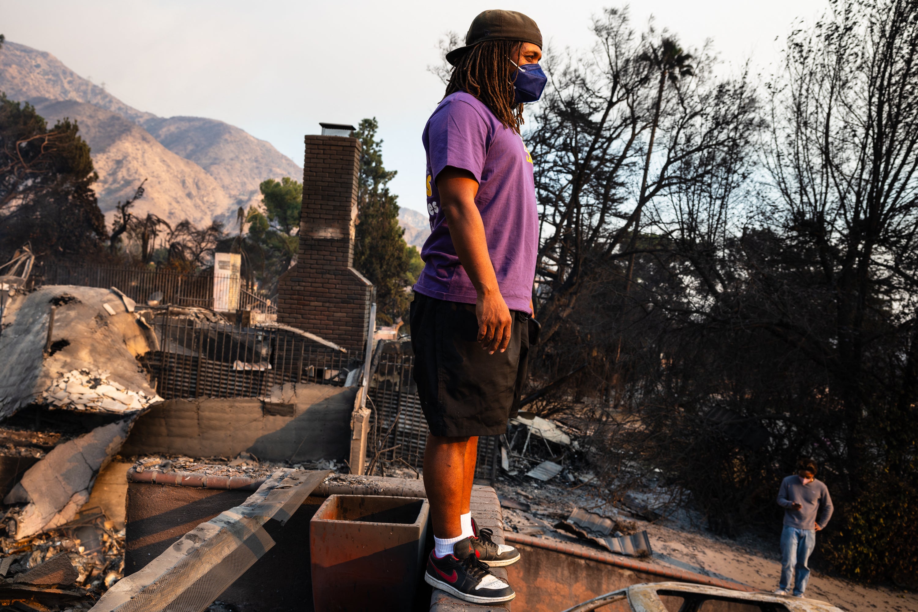 A young man looks out across the destruction from his family's home burned in the Eaton Fire in Altadena, California, in January 2025. Black Americans are at a higher risk of developing dementia