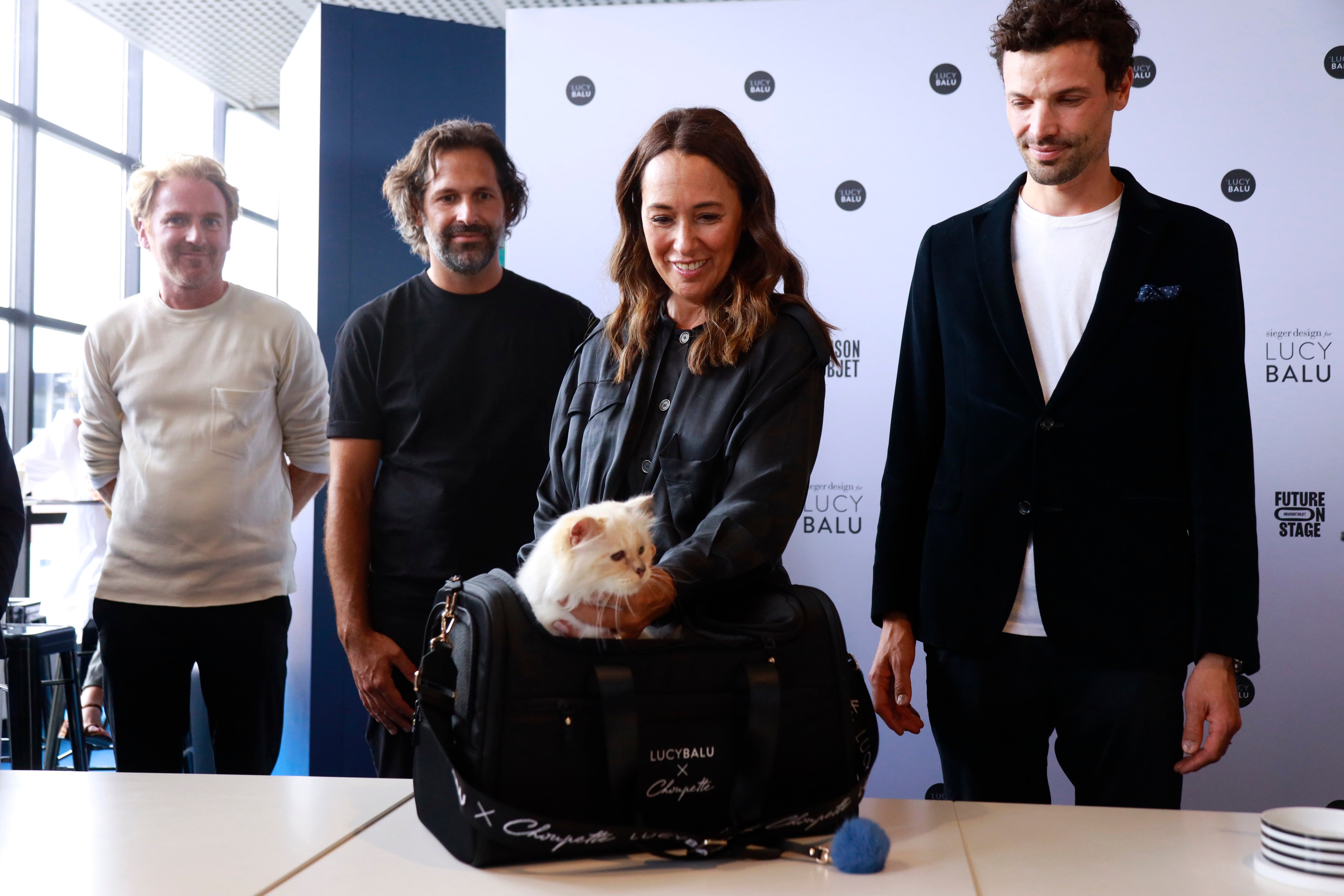 Françoise Caçote (second from right), Choupette, and Lucas Bérullier (right) during a product presentation in Paris, France