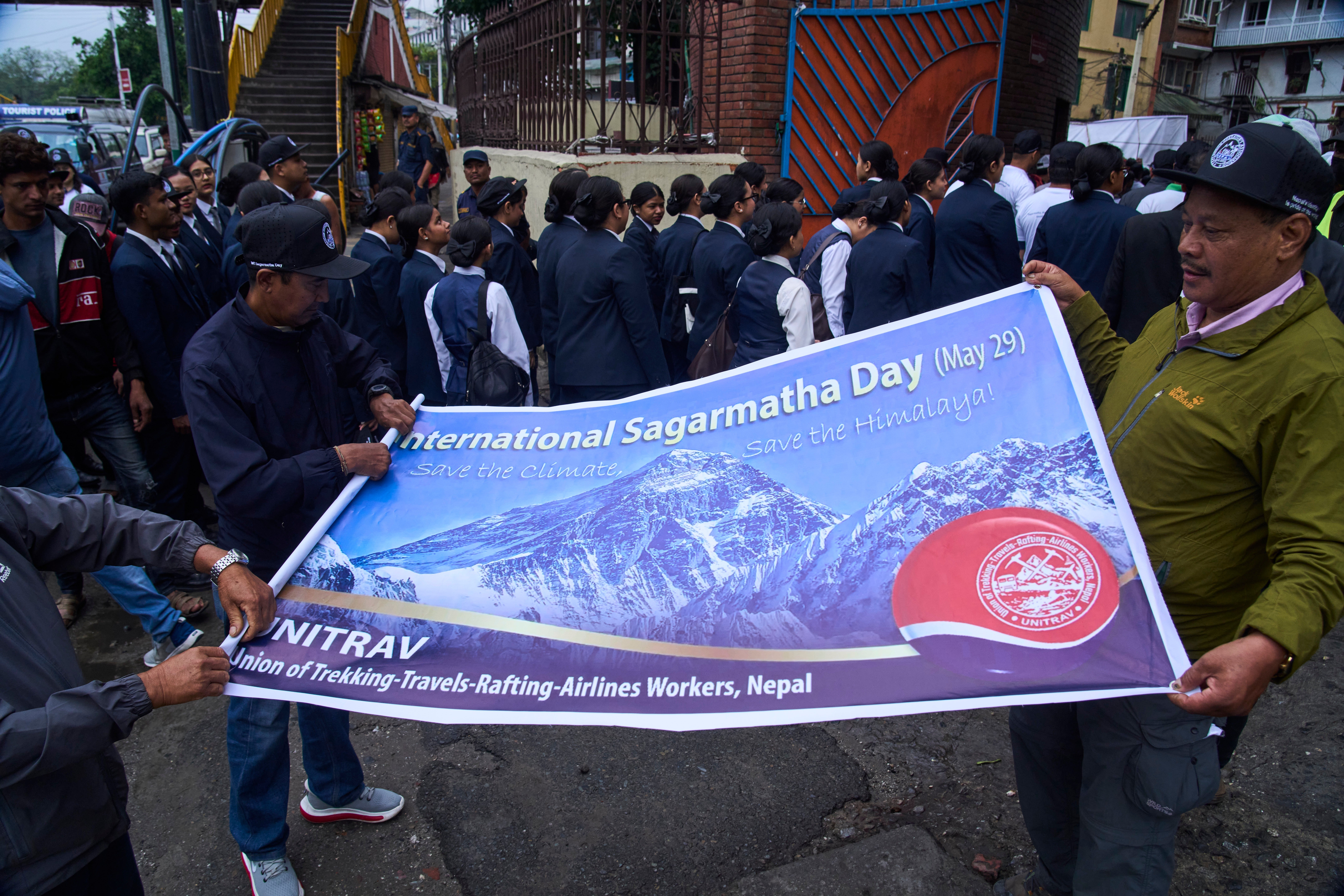 Nepalese people carry a banner with the photo of Mount Everest during a rally to mark Everest Day in Kathmandu, Nepal, Friday, 29 May 2026 (AP)