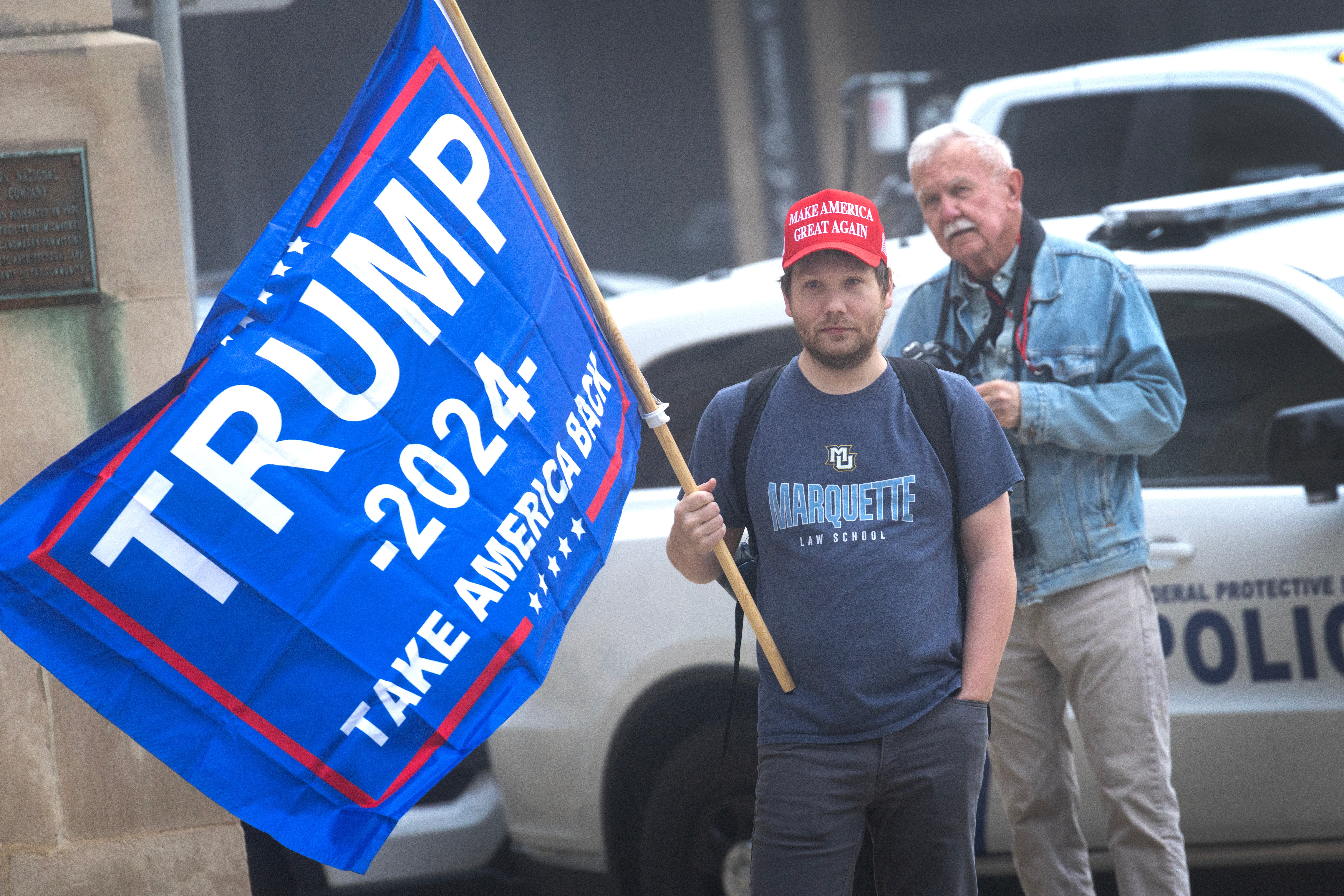 A supporter of President Donald Trump stands across the street as supporters of Milwaukee County Circuit Judge Hannah Dugan demonstrate outside of the Milwaukee Federal Courthouse while she was scheduled to appear in court on May 15