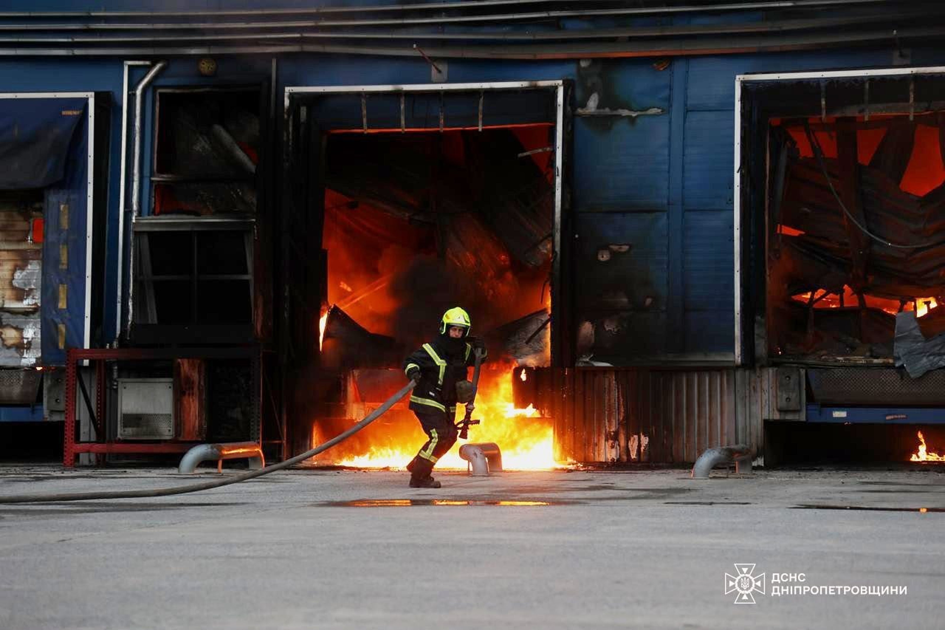 A rescue worker puts out a fire of a storage depot damaged after a Russian strike on Dnipropetrovsk region on Thursday (AP)