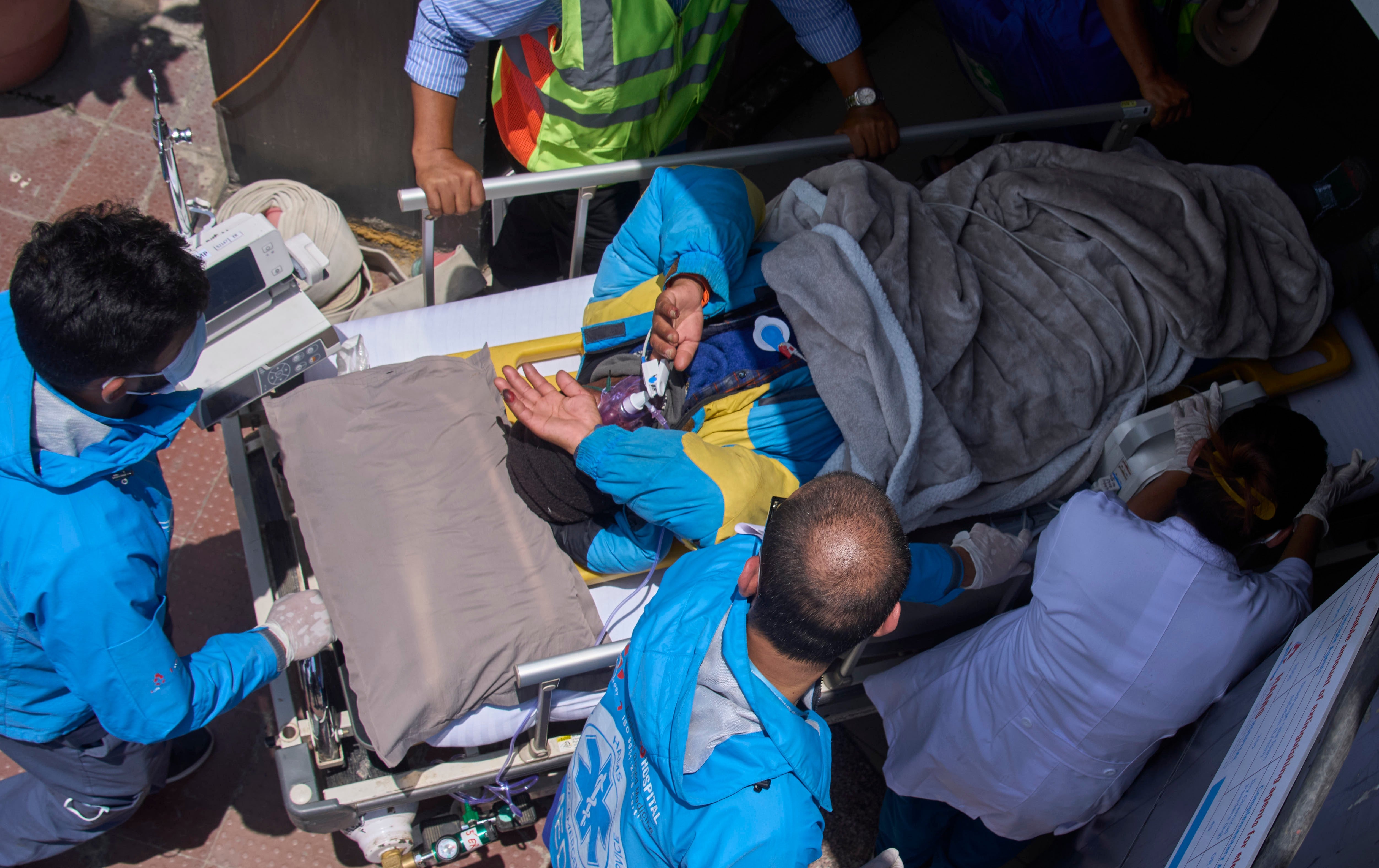 Medics take Dawa Sherpa, a mountain guide who had been missing for several days in the Everest region (AP)
