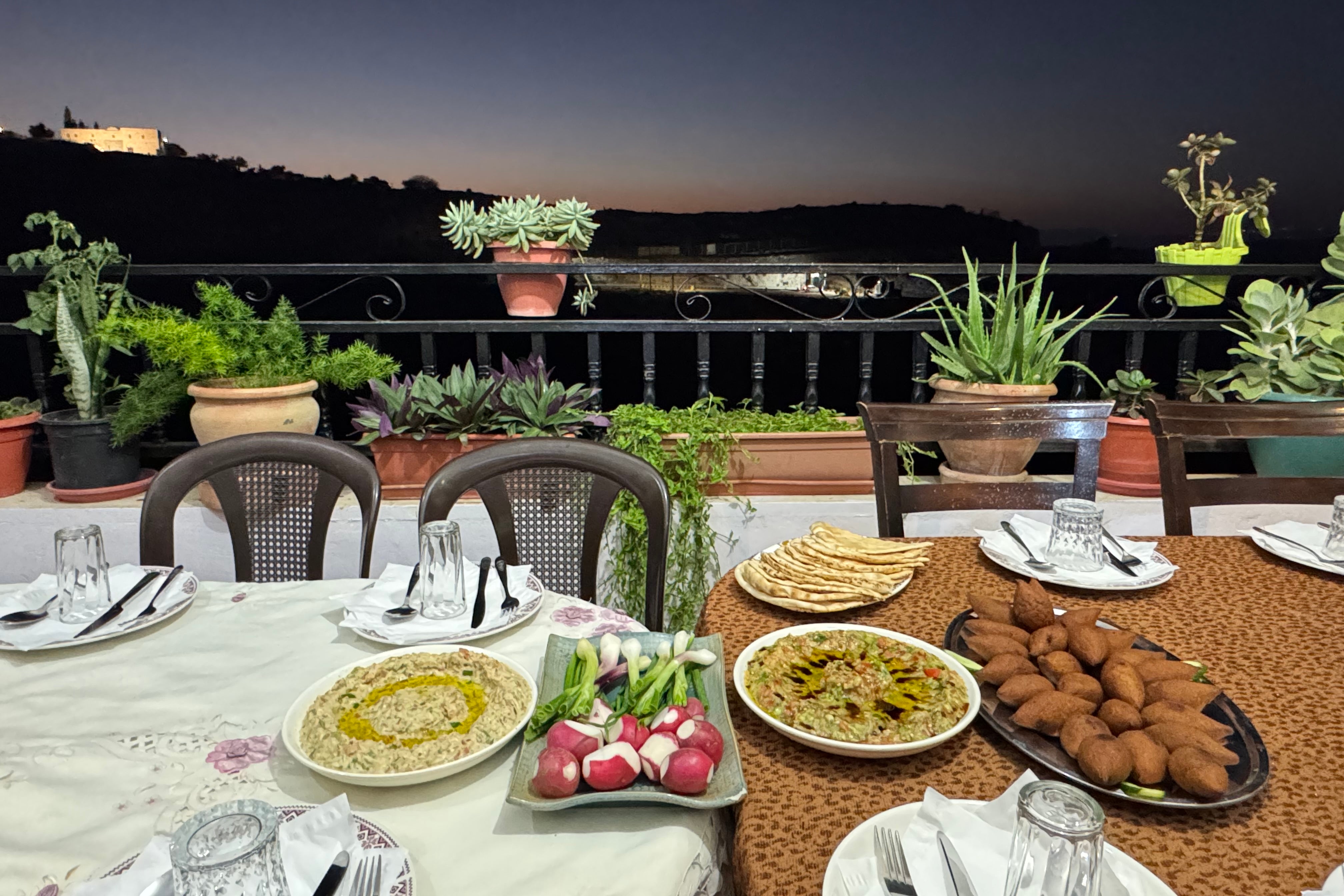 Dinner is served on the balcony at Rufaida and Maher Kiwan's house (Claire Dodd)