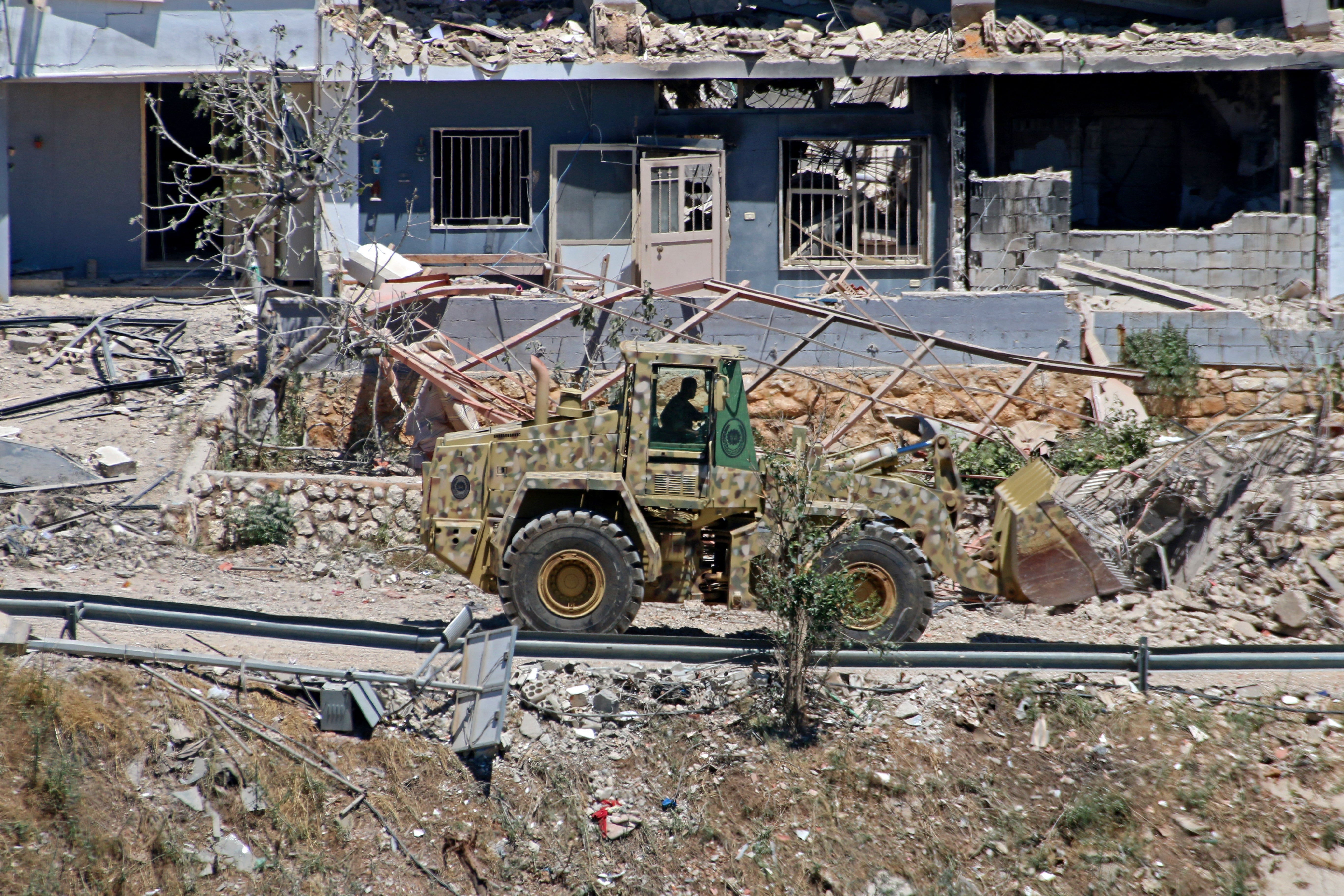 A Lebanese army bulldozer advances along the main road in the southern border village of Debbine on June 4, 2026, as the Israeli military reportedly begins a gradual withdrawal from the village. Israel carried out new strikes in Lebanon and again threatened Beirut, despite the two countries agreeing to a conditional ceasefire that Lebanon's president called the 