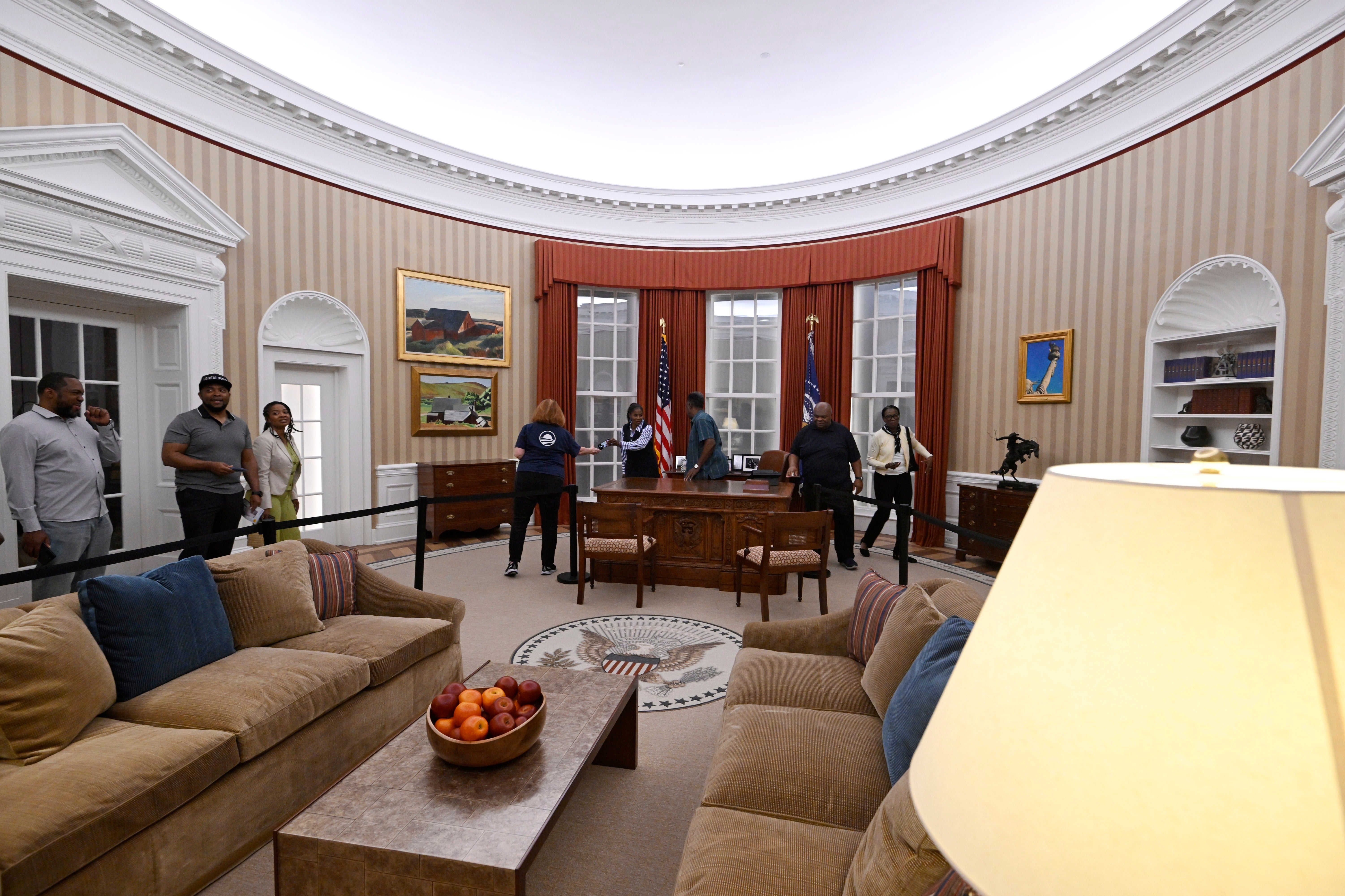 Visitors tour a replica of former President Barack Obama's Oval Office at the Obama Presidential Center