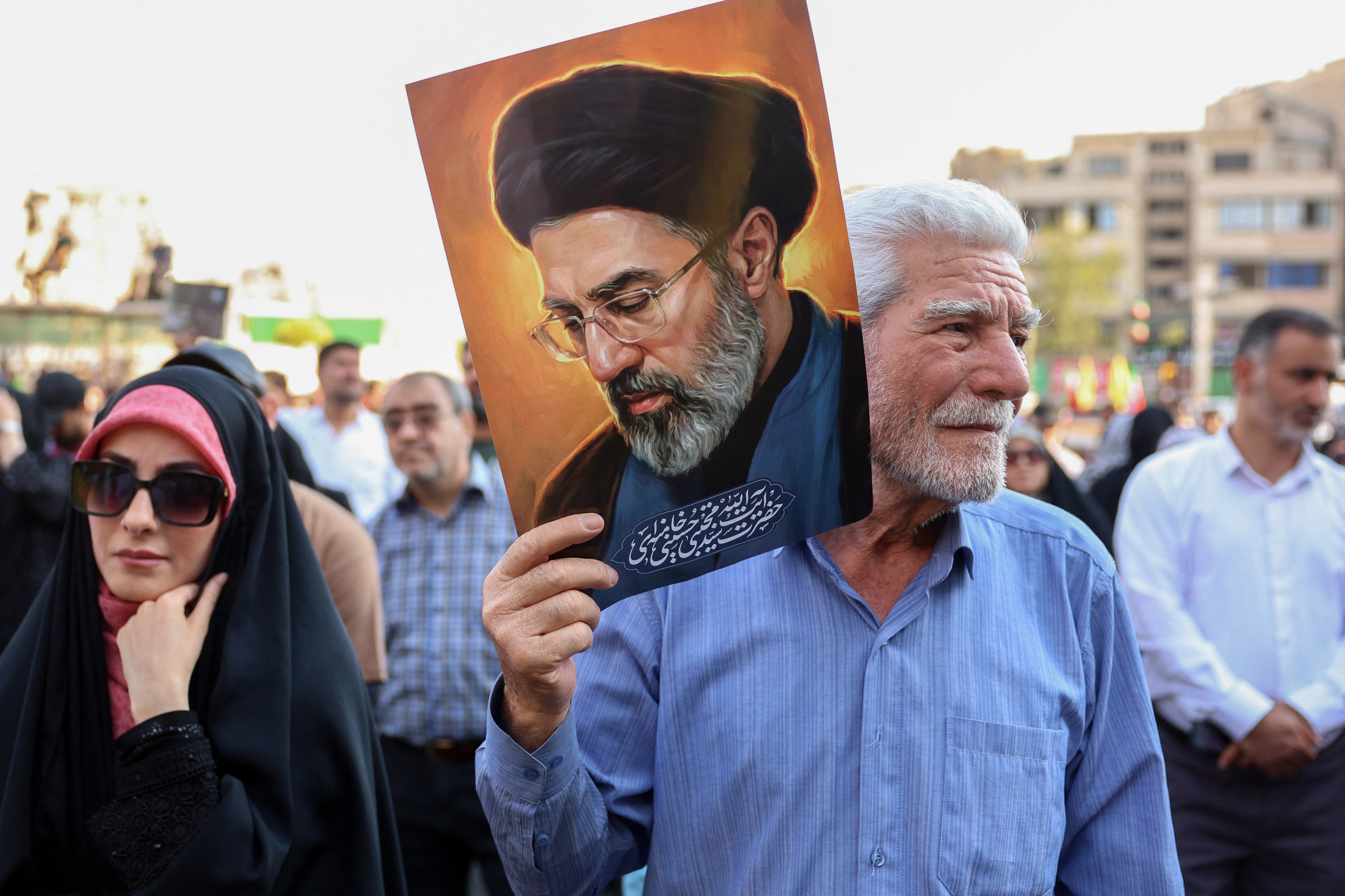 Iranians take part during a rally in support of the country's supreme leader Mojtaba Khamenei (pictured) and commemorate Eid al-Ghadir in Tehran (AFP/Getty)
