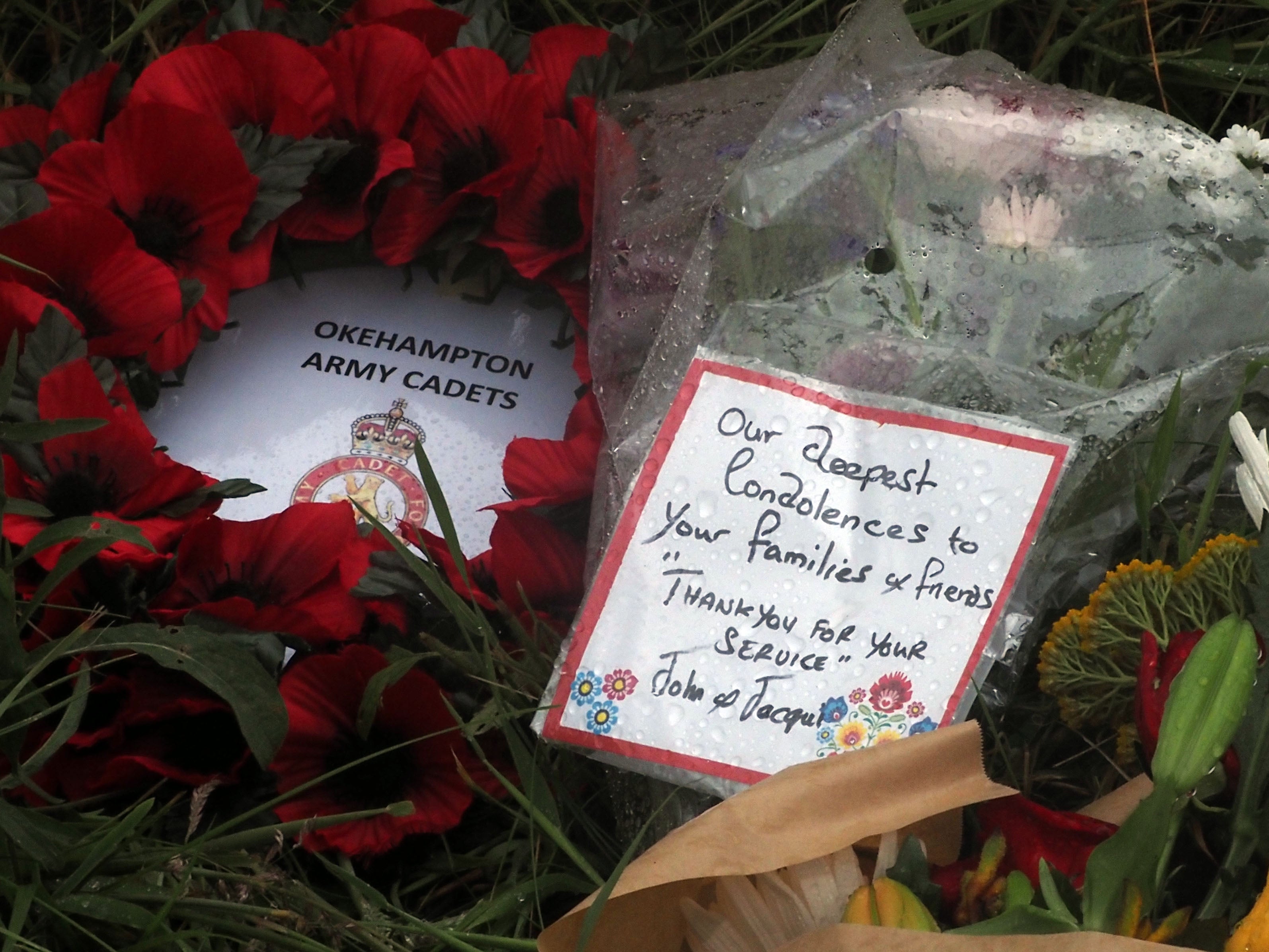 Flowers have been laid near the scene of a Royal Navy helicopter crash in a field at Sourton Down, near Okehampton in Devon