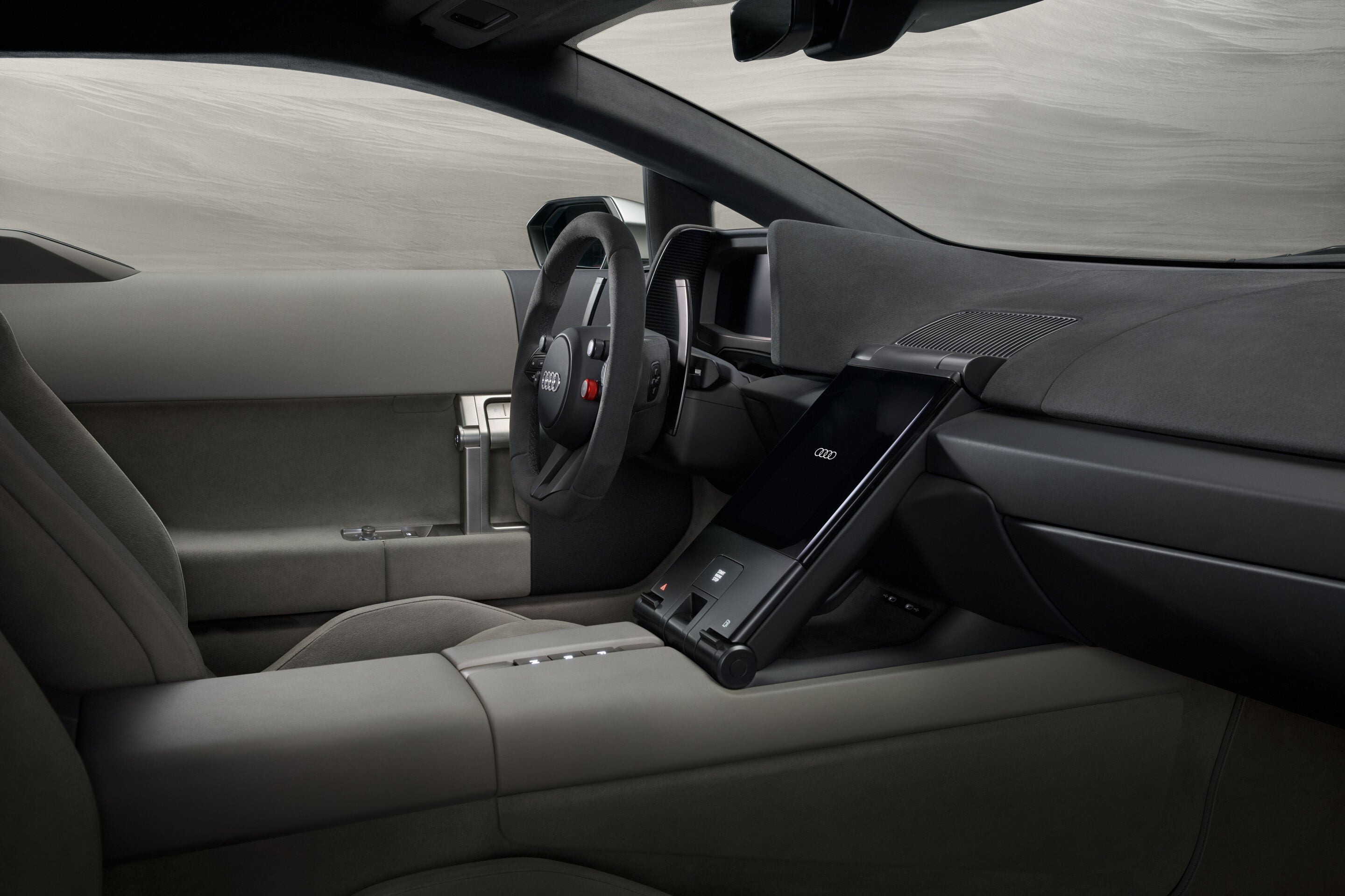 The minimalist interior of the Audi Nuvolari uses darker materials at the front to help concentration
