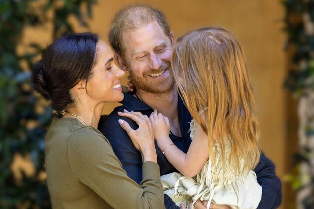Prince Harry and Meghan with Princess Lilibet in June