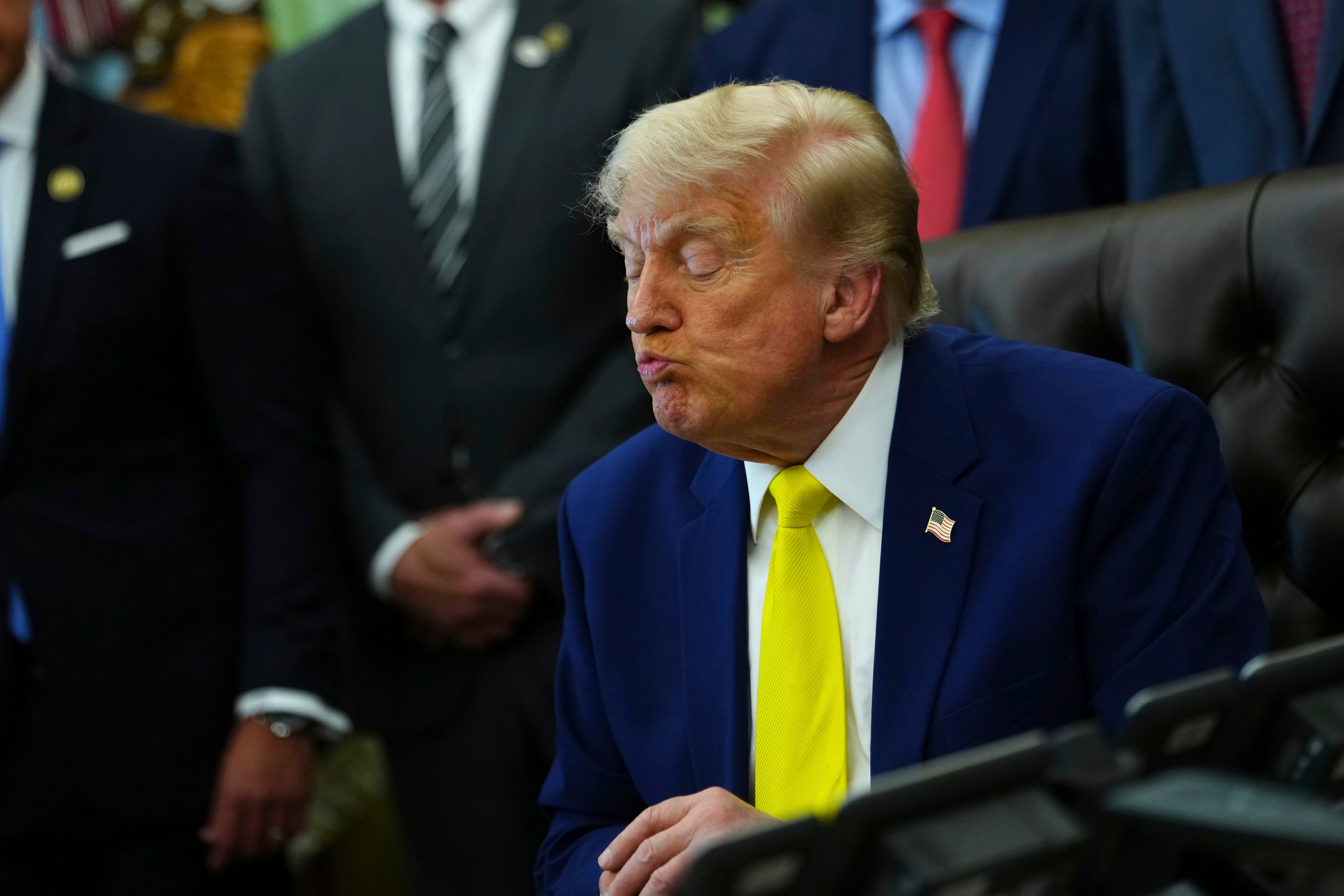 President Donald Trump listens at an event about coal