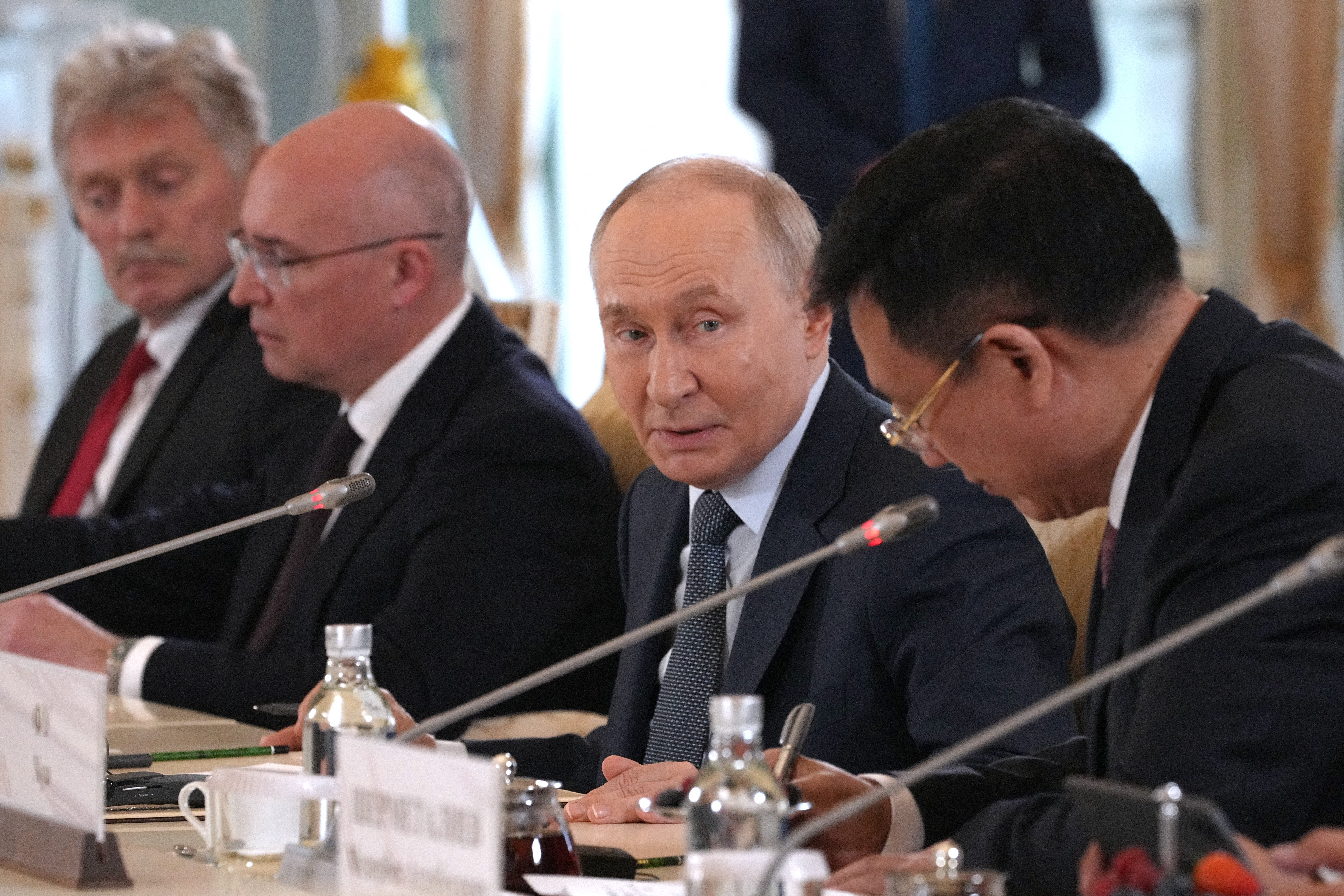 Russian president Vladimir Putin speaks to president of Xinhua News Agency Fu Hua during a meeting on the sidelines of the St. Petersburg International Economic Forum at the Constantine Palace in Saint Petersburg