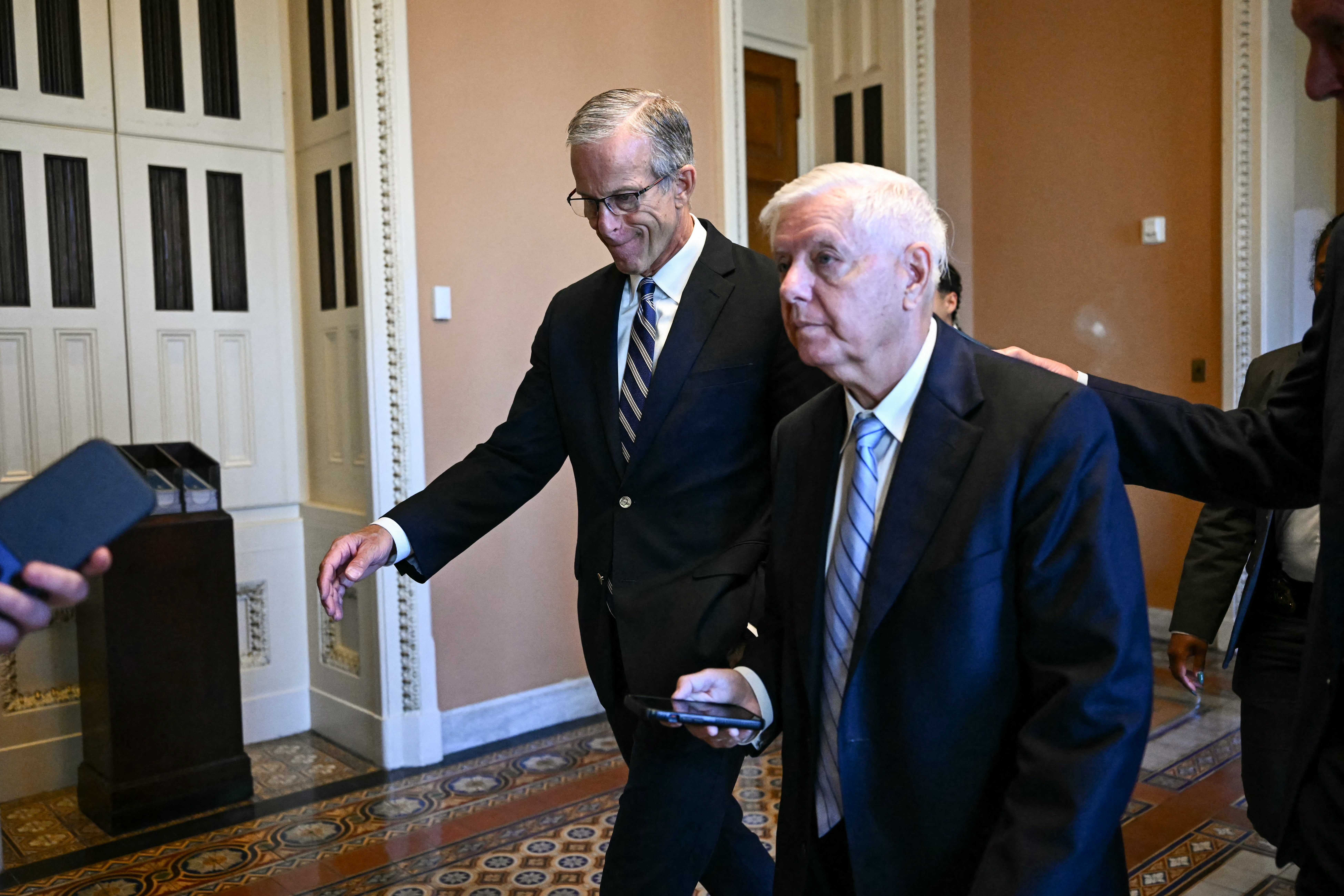 Senate Majority Leader John Thune, Republican from South Dakota, walks with Senator Lindsey Graham, Republican from South Carolina