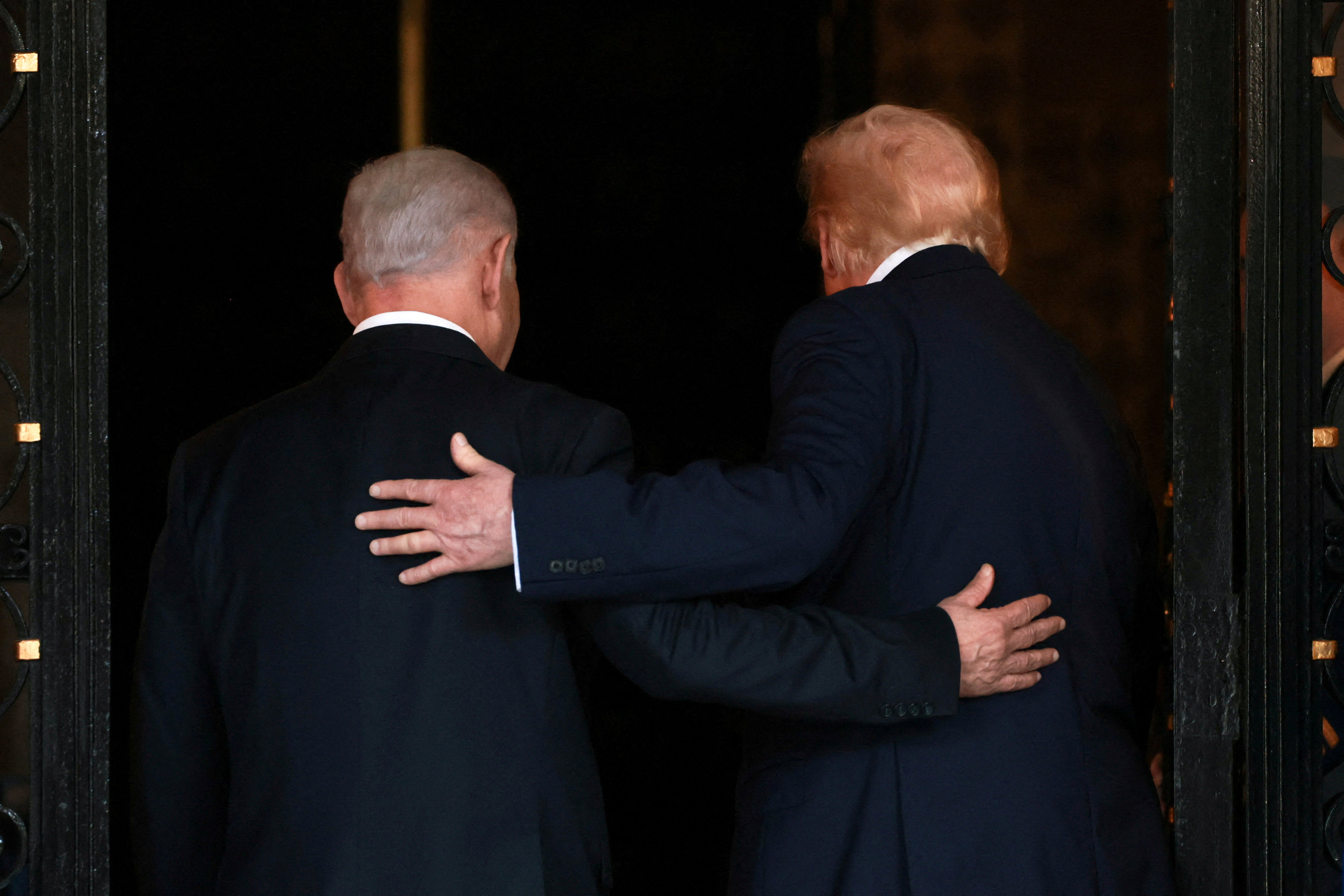 US. President Donald Trump and Israeli Prime Minister Benjamin Netanyahu embrace as they walk into Trump's Mar-a-Lago club in Palm Beach, Florida, U.S., December 29, 2025.