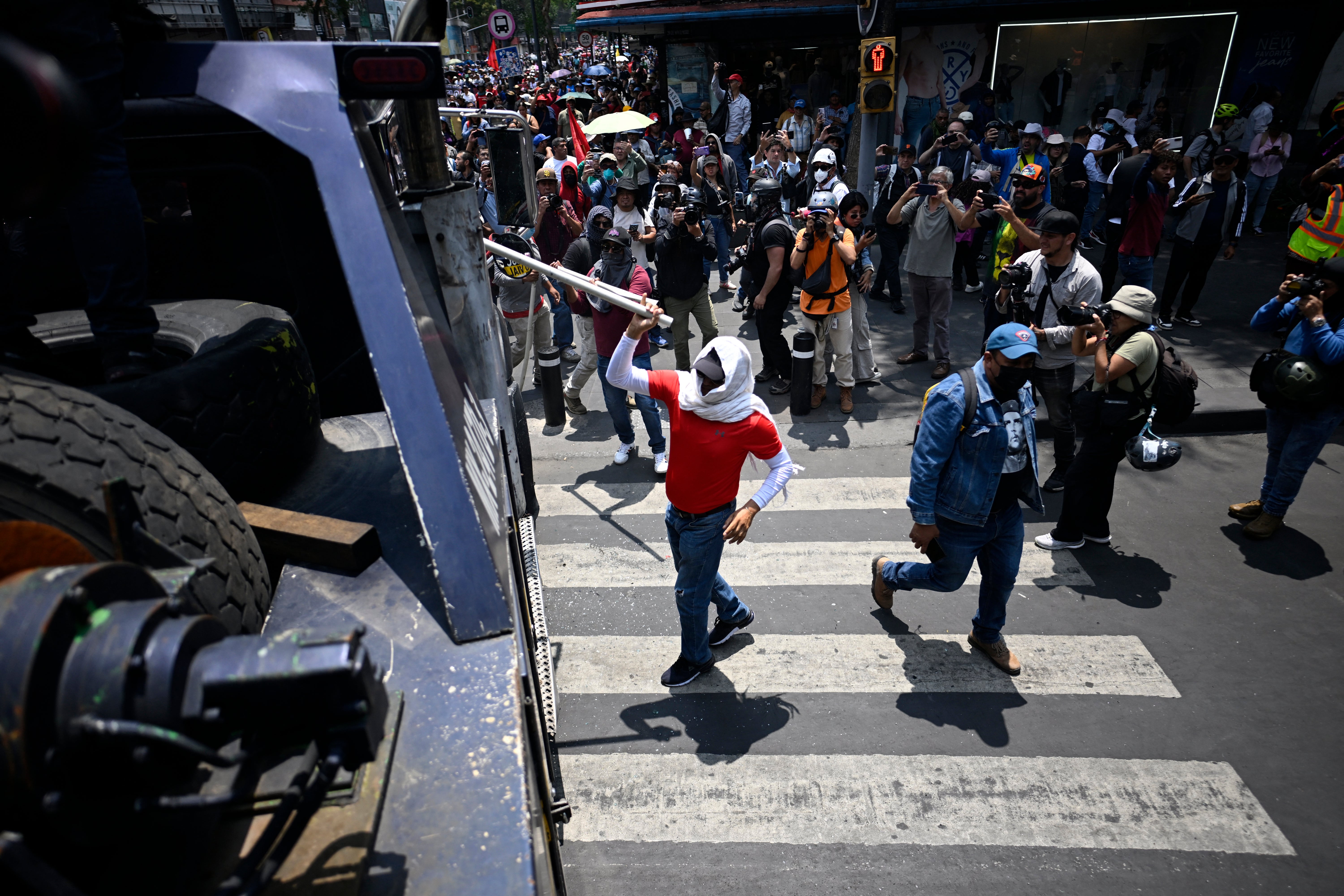 A protester hits a police crane during a protest by teachers ahead of the 2026 FIFA World Cup, in Mexico City