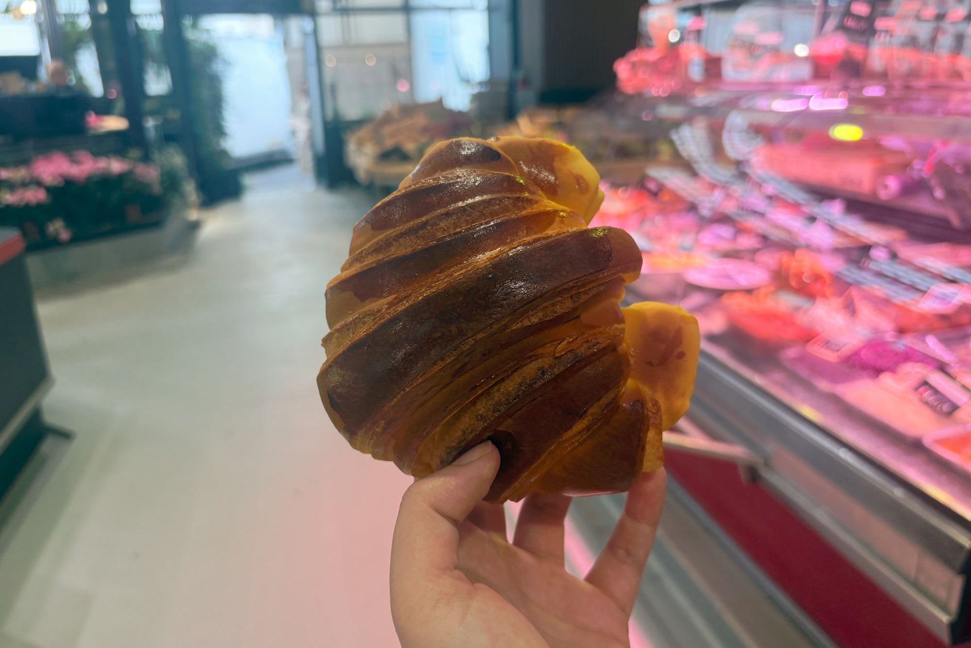 Passy’s indoor market sells handmade croissants (Amelia Neath/The Independent)