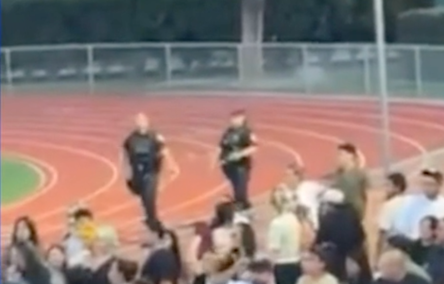 Two police officers rushed onto the field to separate the fighting students