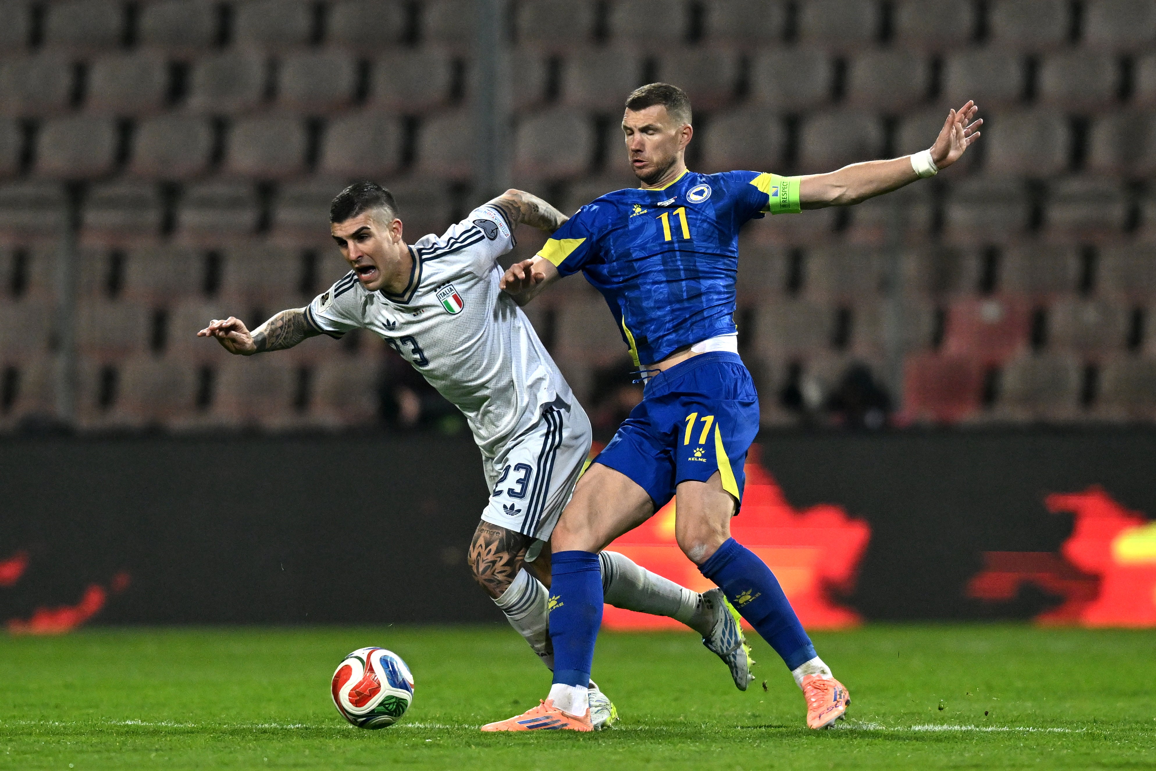 Edin Dzeko of Bosnia & Herzegovina competes for the ball with Gianluca Mancini of Italy (Getty)
