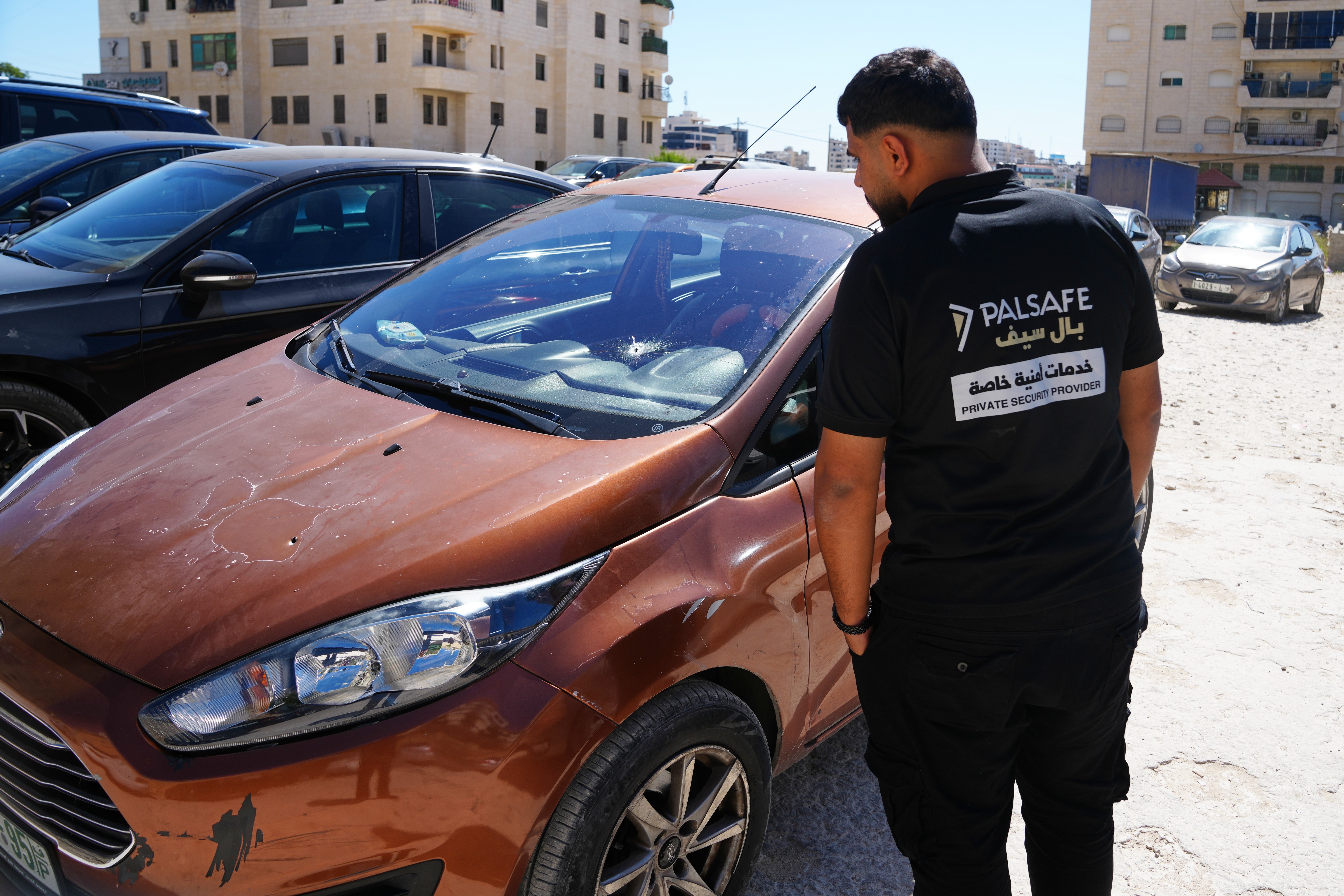A man inspects the shattered family vehicle of seven month old Palestinian baby boy Sam Fahd Abu Heikal, who was killed on Friday when Israeli soldiers fired at the vehicle carrying him and his parents, in Tel Rumeida, in the West Bank city of Hebron Saturday, June 6, 2026. (AP Photo/Mahmoud Illean)