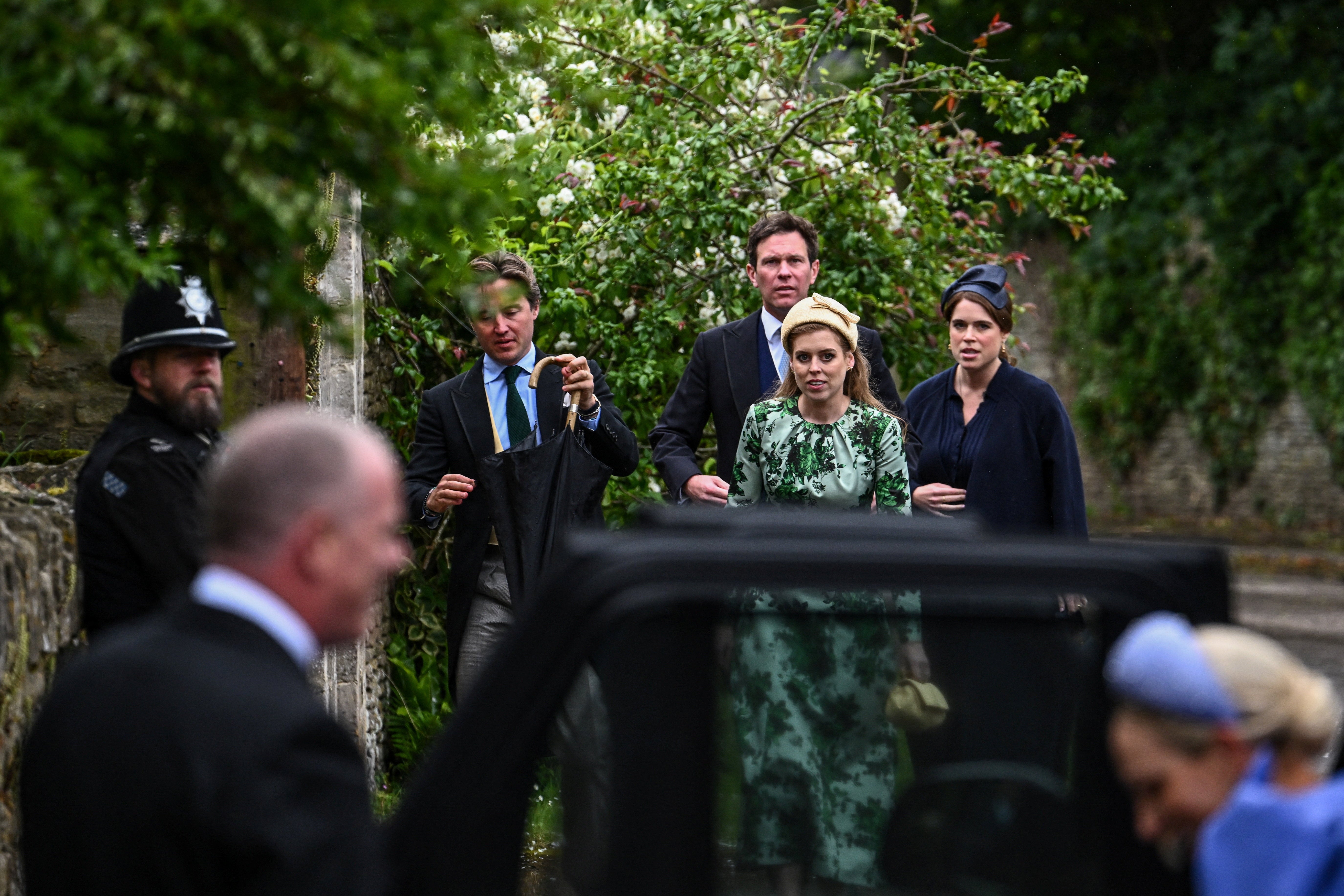 Britain's Princess Beatrice and Princess Eugenie arrive to attend the wedding of Princess Anne's son, Peter Phillips