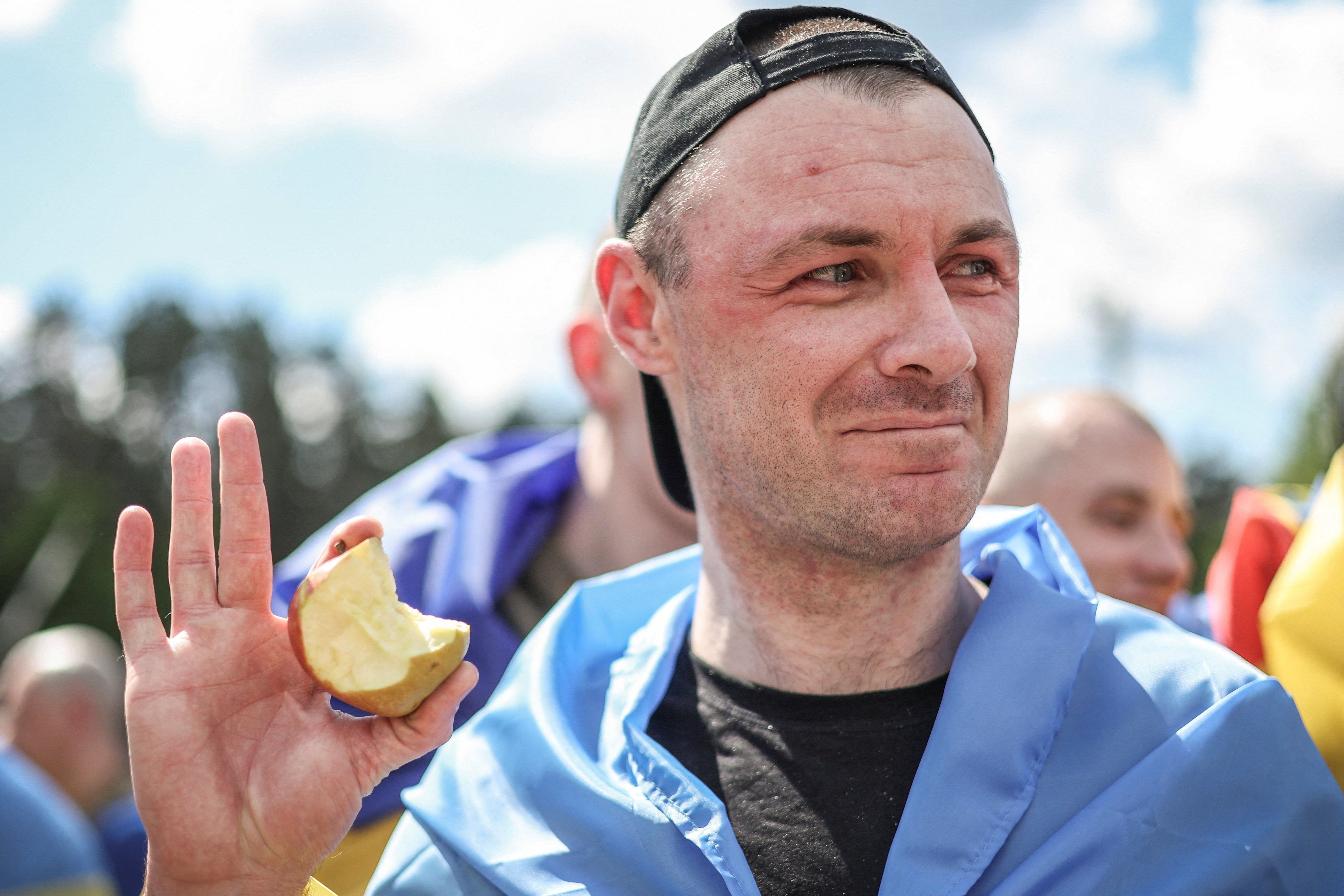 A Ukrainian prisoner of war eats an apple after a swap, in Ukraine on Friday (Reuters)