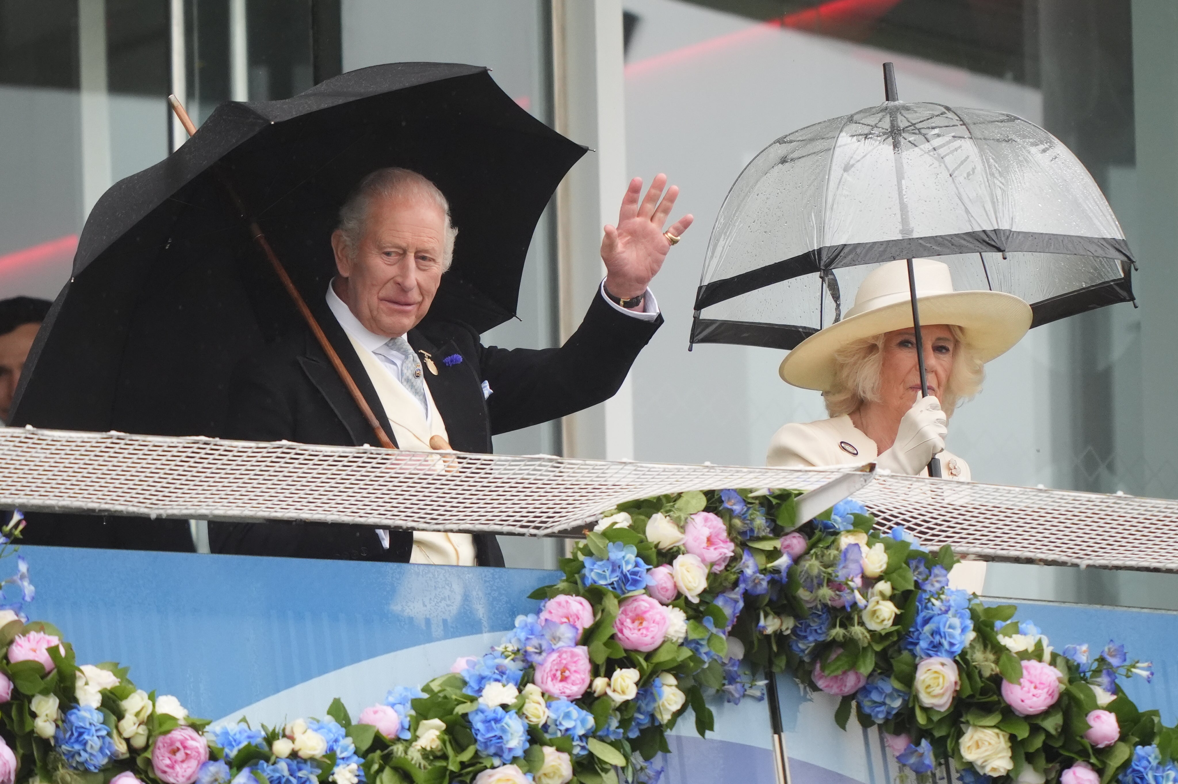 The King and Queen wave to the crowd from the royal box (Jonathan Brady/PA) (PA Wire)