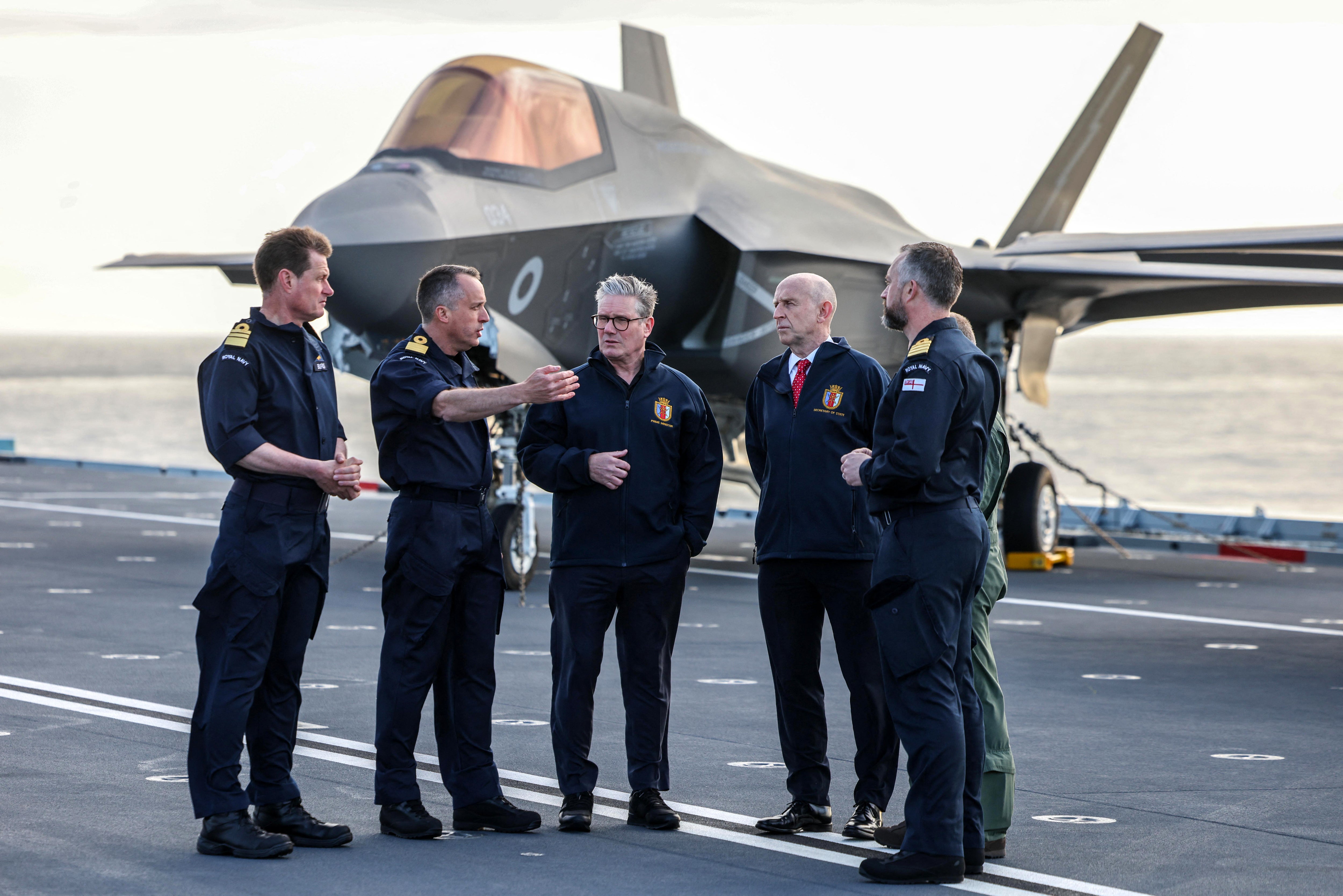 Keir Starmer and defence secretary John Healey in front of a Royal Navy F-35B Lightning fighter jet