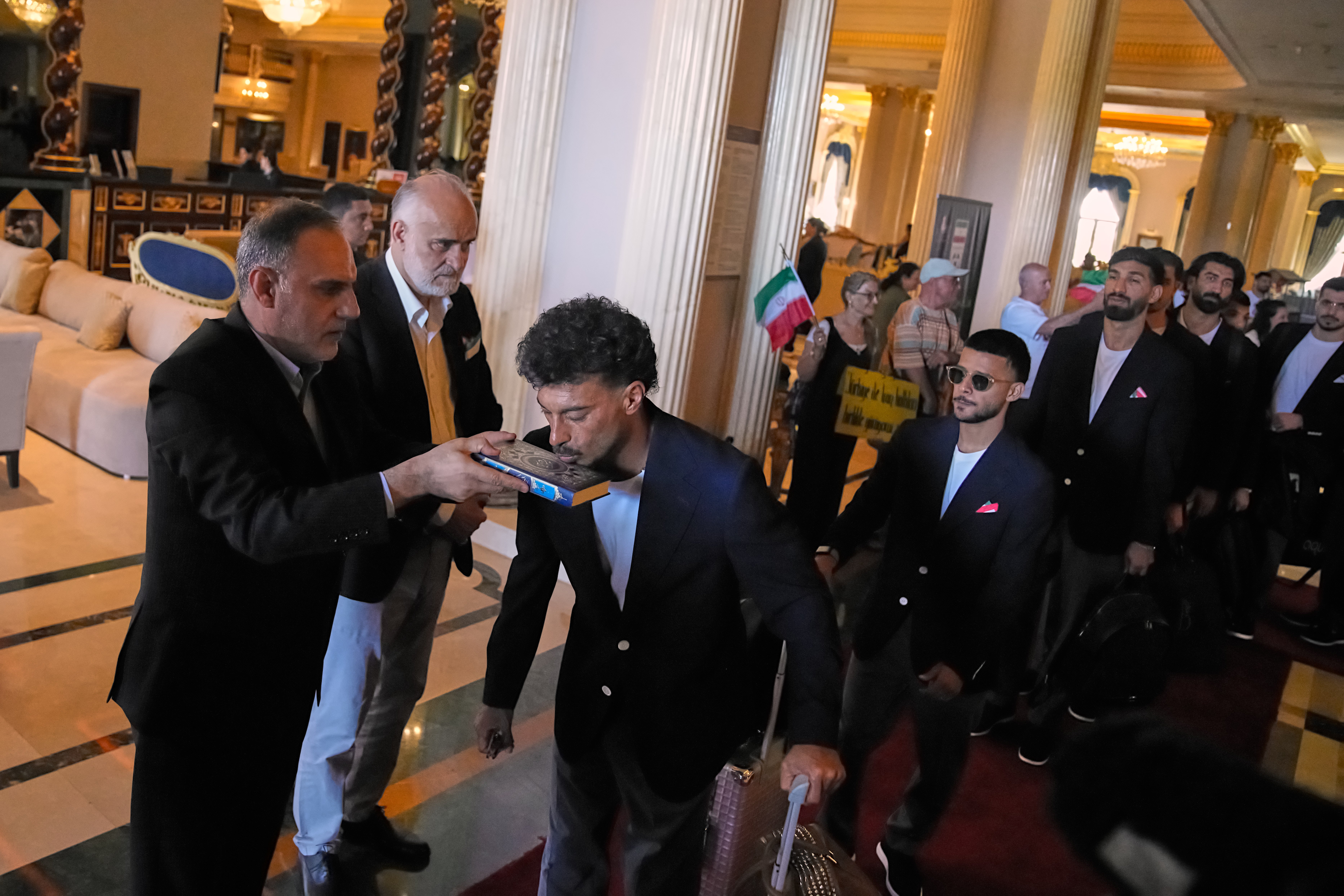 Iran's players kiss the Muslim's holiest book Quran as they leave to Antalya airport, southern Turkey (AP)