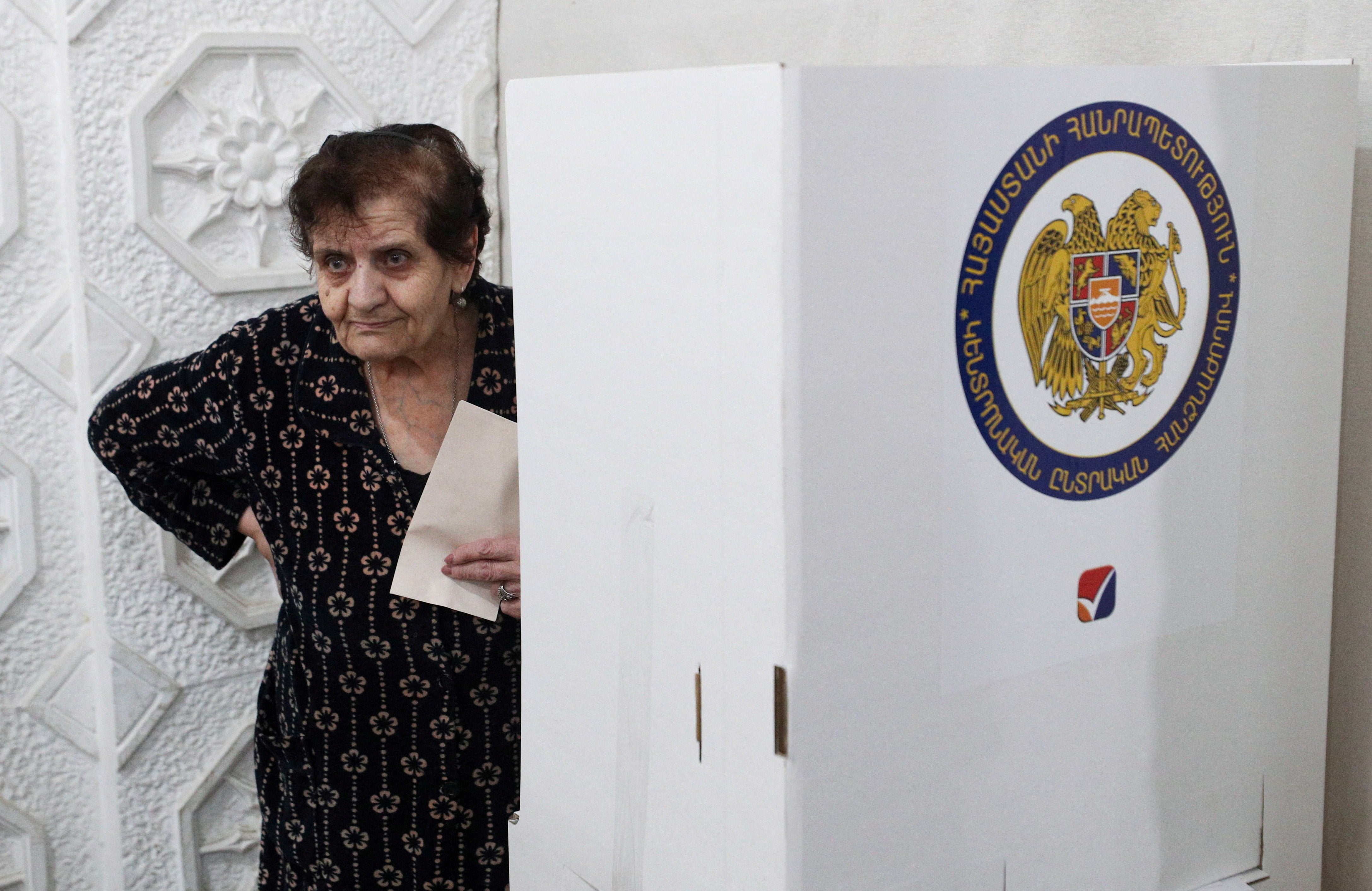 A voter holds a ballot at a polling station during a parliamentary election in Yerevan, Armenia, June 7, 2026 (Reuters)