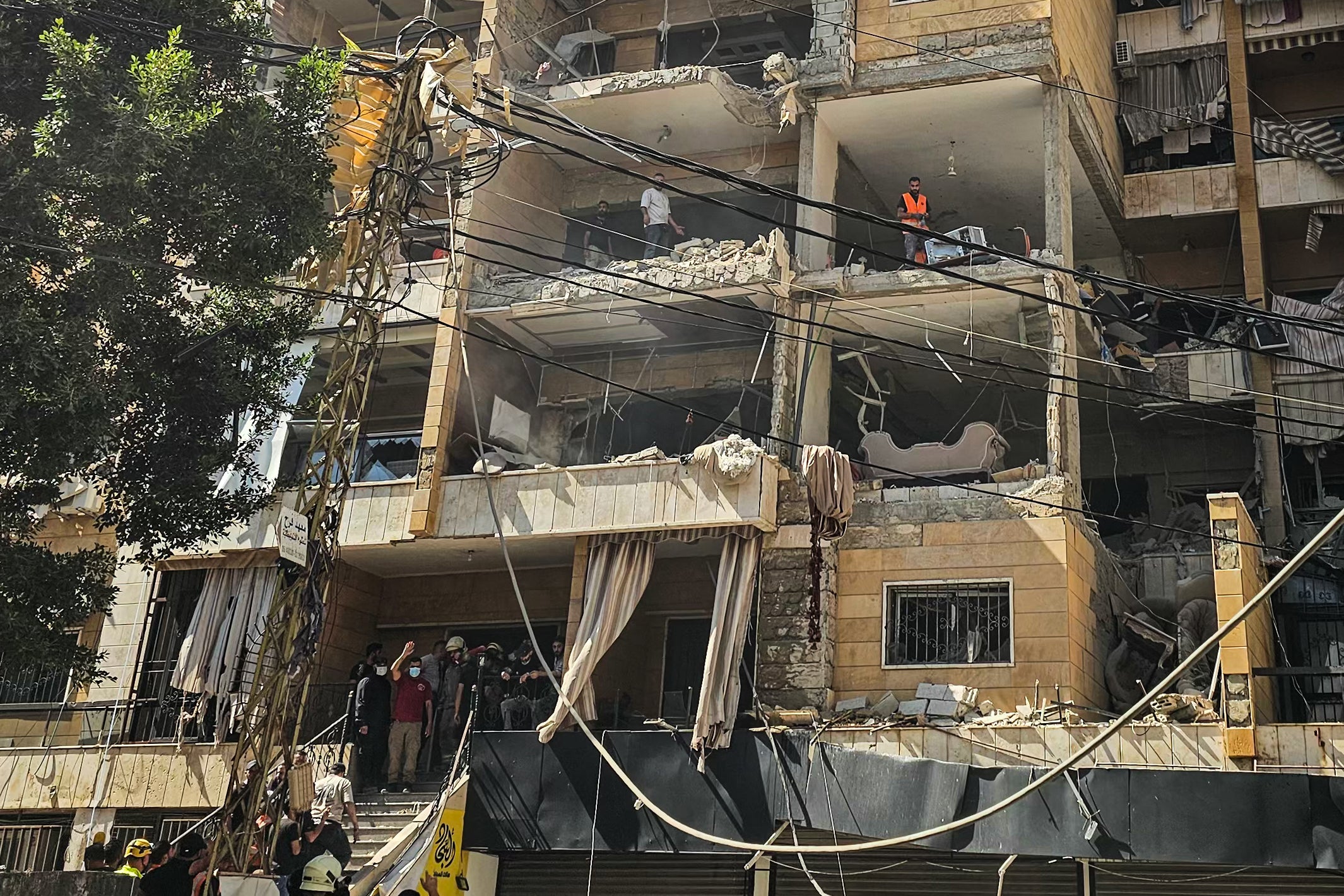 First responders inspect damage at the site of an Israeli airstrike on an apartment building in Beirut's southern suburbs on June 7 (AFP/Getty)