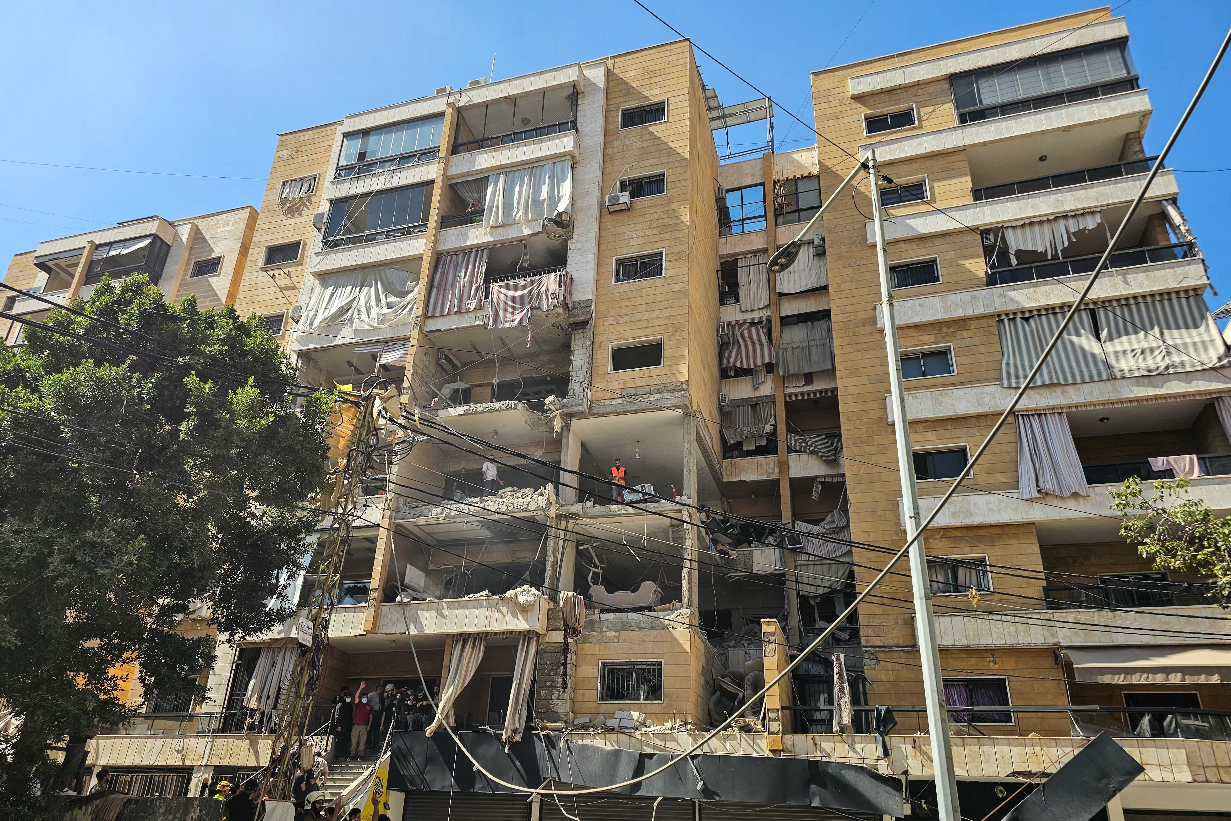 First responders inspect damage at the site of an Israeli airstrike on an apartment building in Beirut (AFP/Getty)