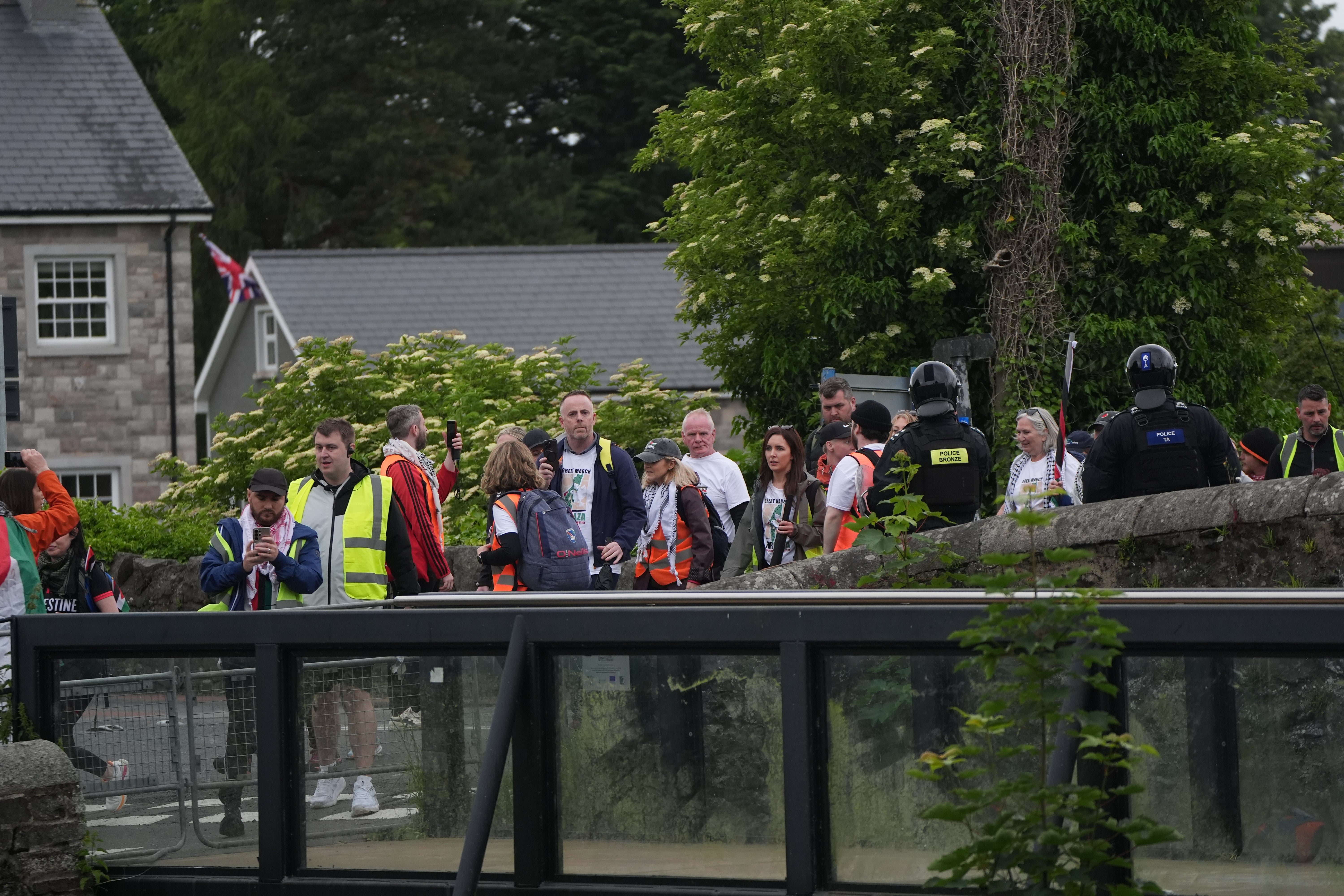 The pro-Palestinian march under protection of PSNI officers passes the village of Scarva, Co Down as it travels from Lurgan to Newry (Niall Carson/PA) (PA Wire)