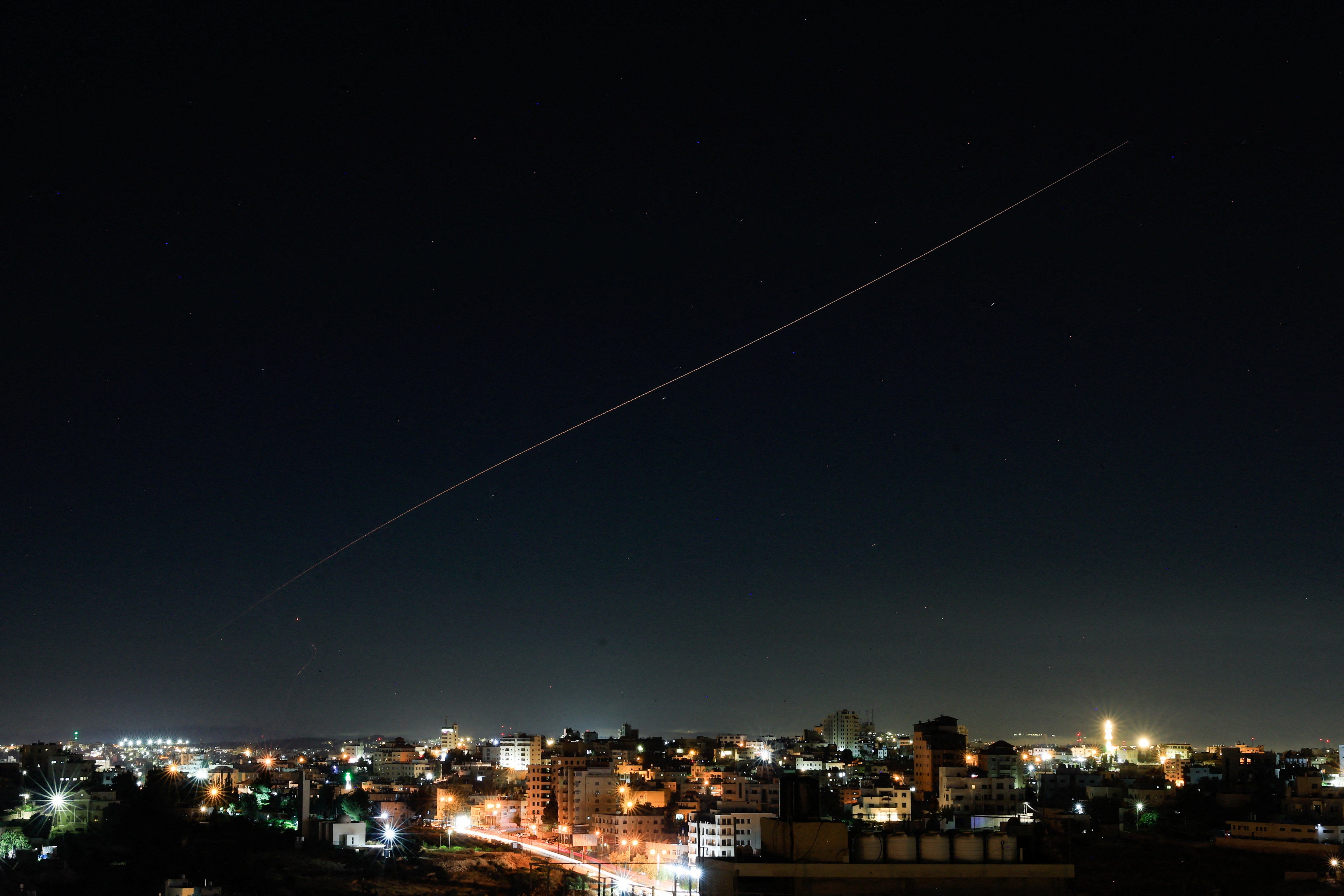 An Iranian missile flies in the sky over Israel, as seen from Hebron, in the Israeli-occupied West Bank, June 7