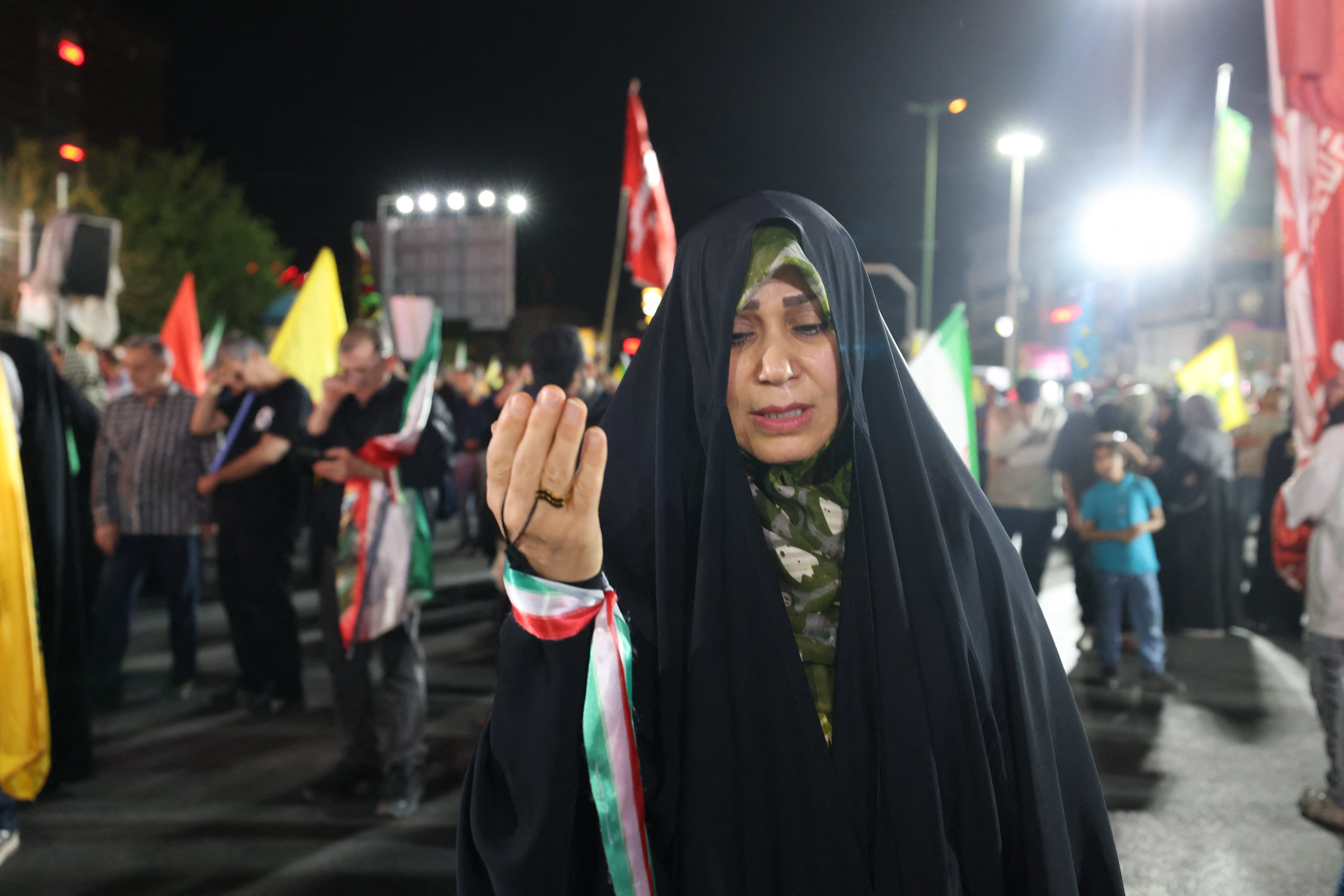 A woman takes part in a pro-government demonstration after Israeli strikes on Beirut's southern suburbs, in Tehran on June 7
