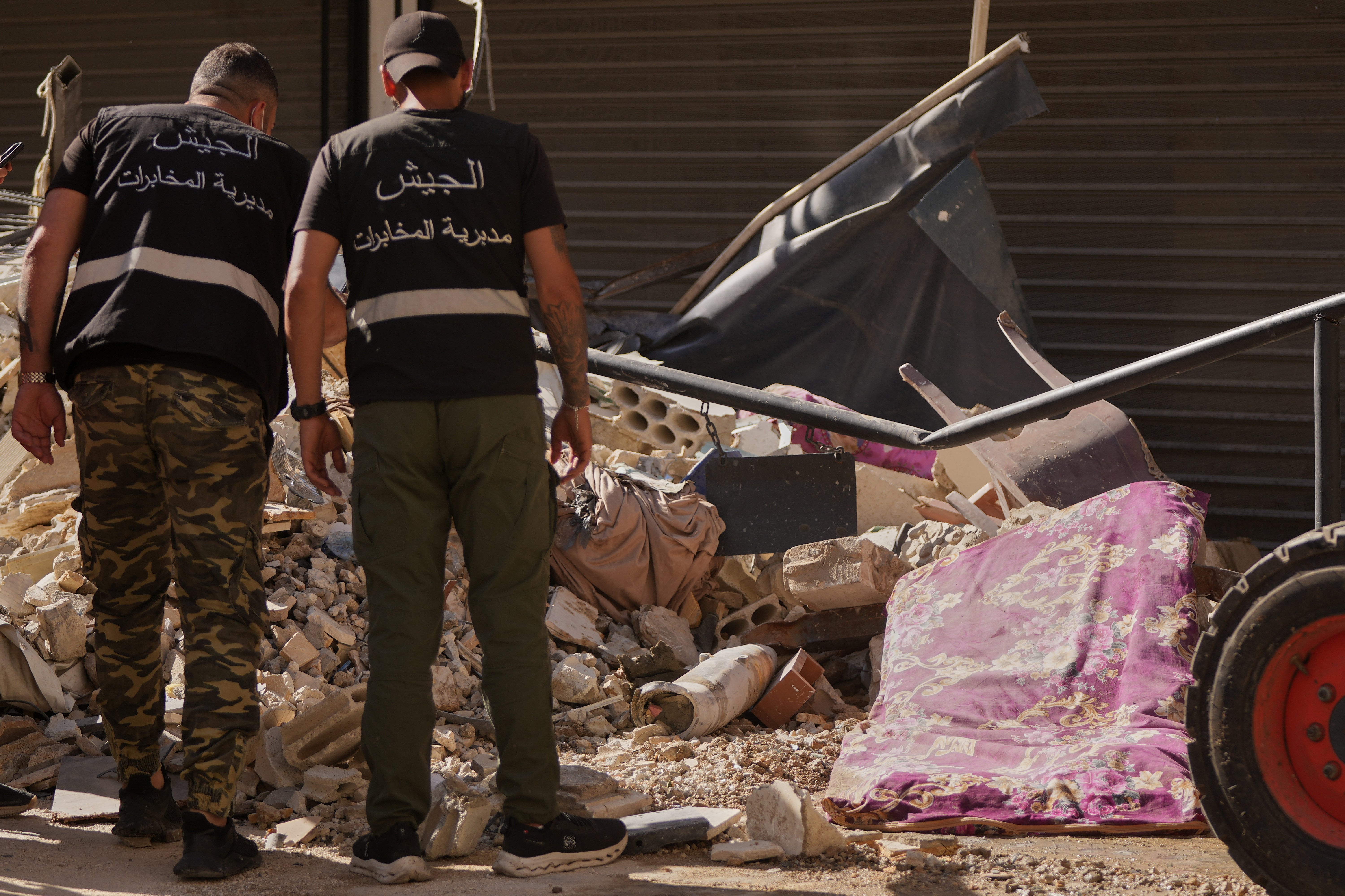 Lebanese intelligence officers look at an unexploded missile, centre, at the site where an Israeli airstrike hit a building in Dahiyeh, Beirut's southern suburb, Lebanon, Sunday, June 7, 2026