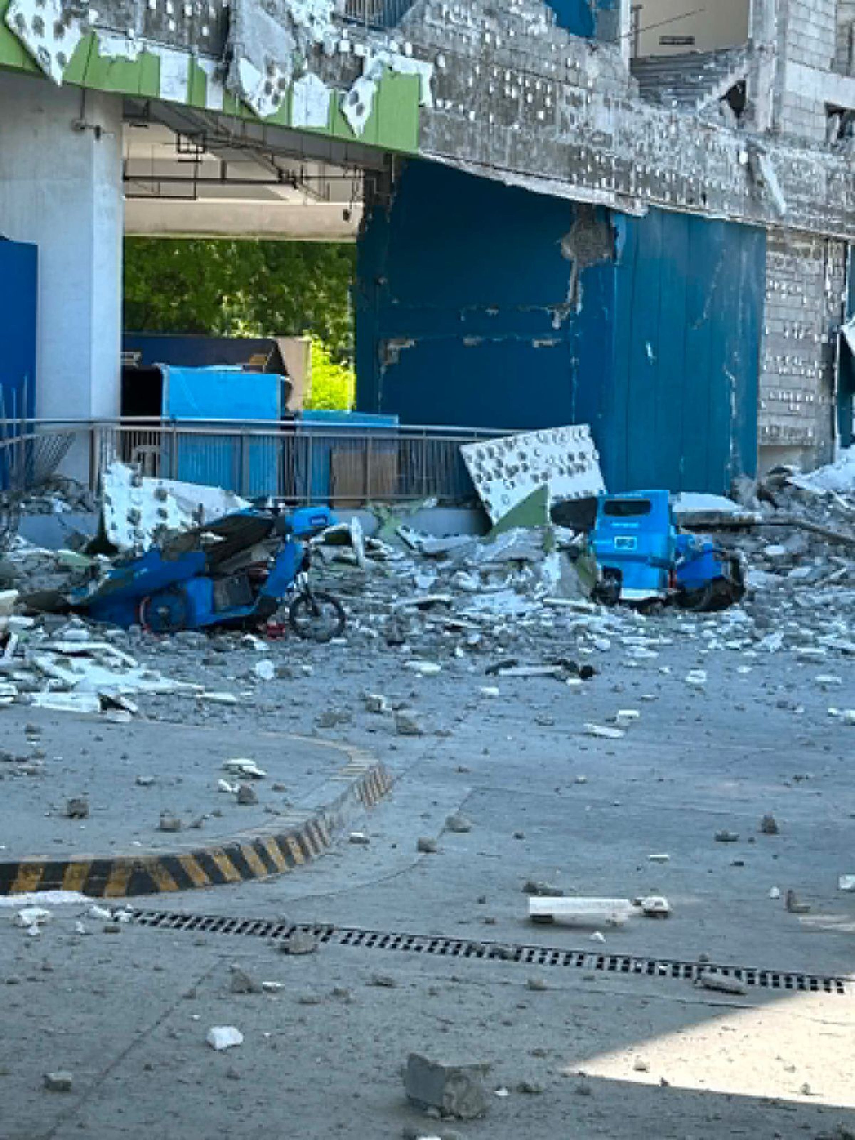 Vehicles damaged by debris after powerful earthquake in the Mindanao region (AP)
